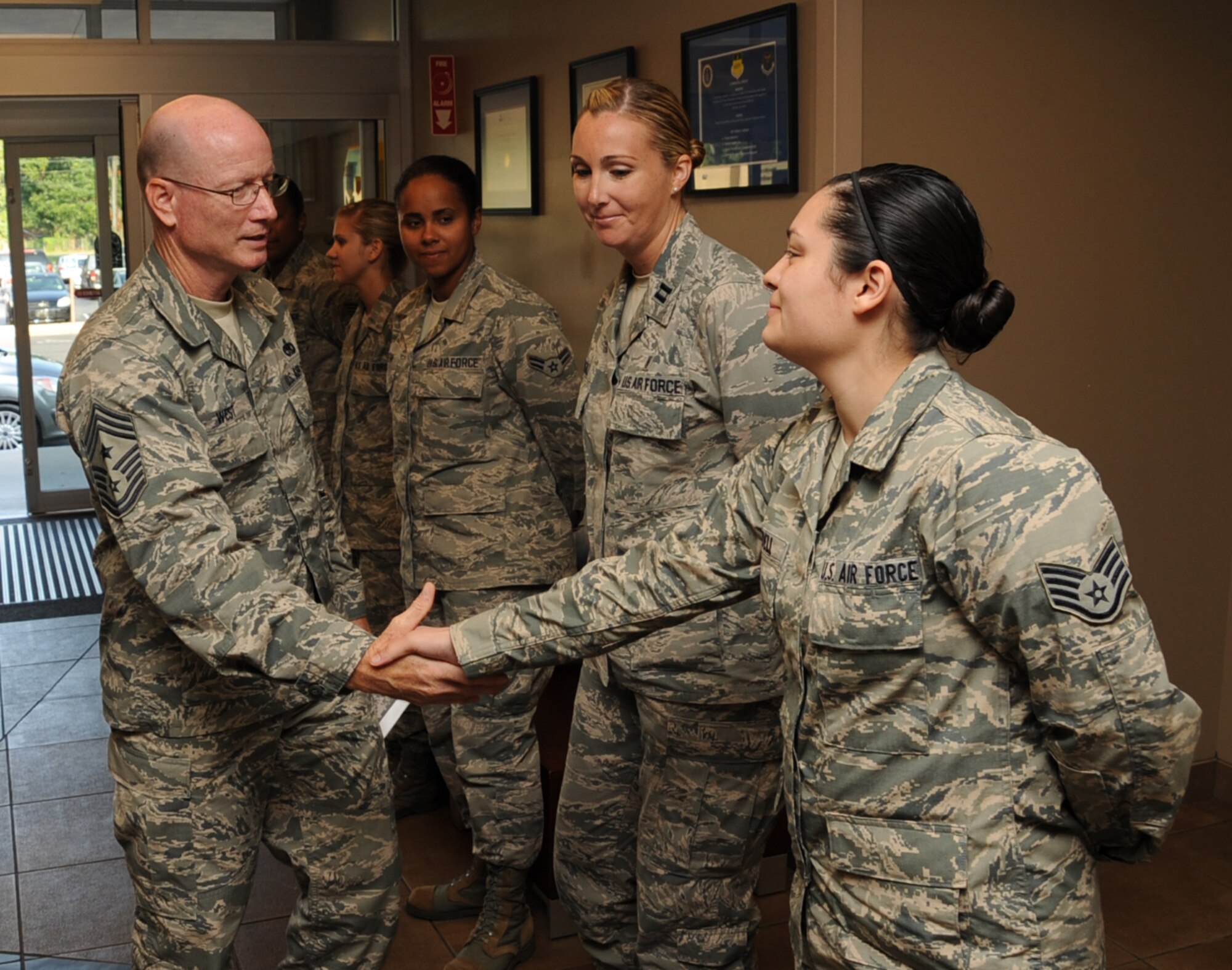 Staff Sgt. Cecily Yandell, 2nd Medical Operations Squadron immunizations technician, greets Chief Master Sgt. Terry West, 8th Air Force command chief, during his visit on Barksdale Air Force Base, La., Aug. 20, 2013. The mission statement of the 2nd Medical Group is to provide the reliability of global war fighters by optimizing their health and that of the Barksdale community with medics prepared to execute their professional responsibilities. (U.S. Air Force photo/Senior Airman Sean Martin)