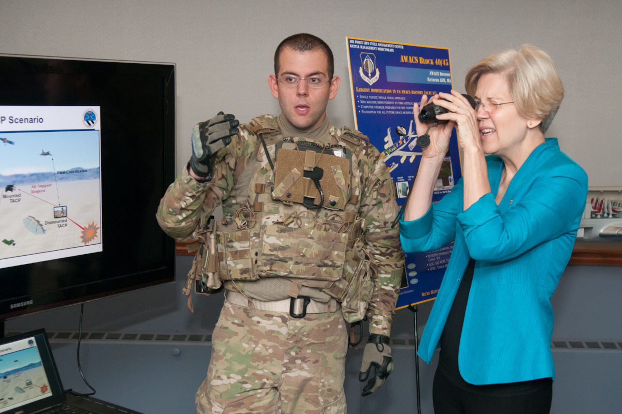 HANSCOM AIR FORCE BASE, Mass. -- U.S. Senator Elizabeth Warren views Tactical Air Control Party equipment during a demonstration by 1st Lt. Joseph Calidonna, Theatre Battle Control Division, during her first full visit here Aug. 20. During her visit, the senator received an Air Force Life Cycle Management Center mission overview, technology demonstrations, a windshield tour of the base and visited the Mass. National Guard Joint Force Headquarters. (U.S. Air Force photo by Rick Berry)