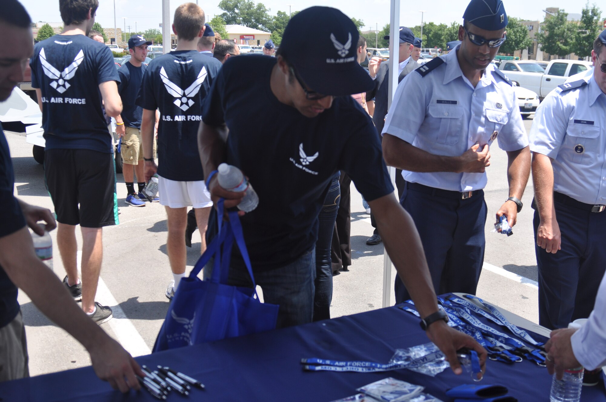 A Delayed Entry Program member picks up some Air Force recruiting give-aways at the 341st Recruiting Squadron hub opening ceremony in Austin, Texas, Aug. 1. More than 60 members of the DEP took the oath of enlistment during the event. (U.S. Air Force photo/Staff Sgt. Hillary Stonemetz)