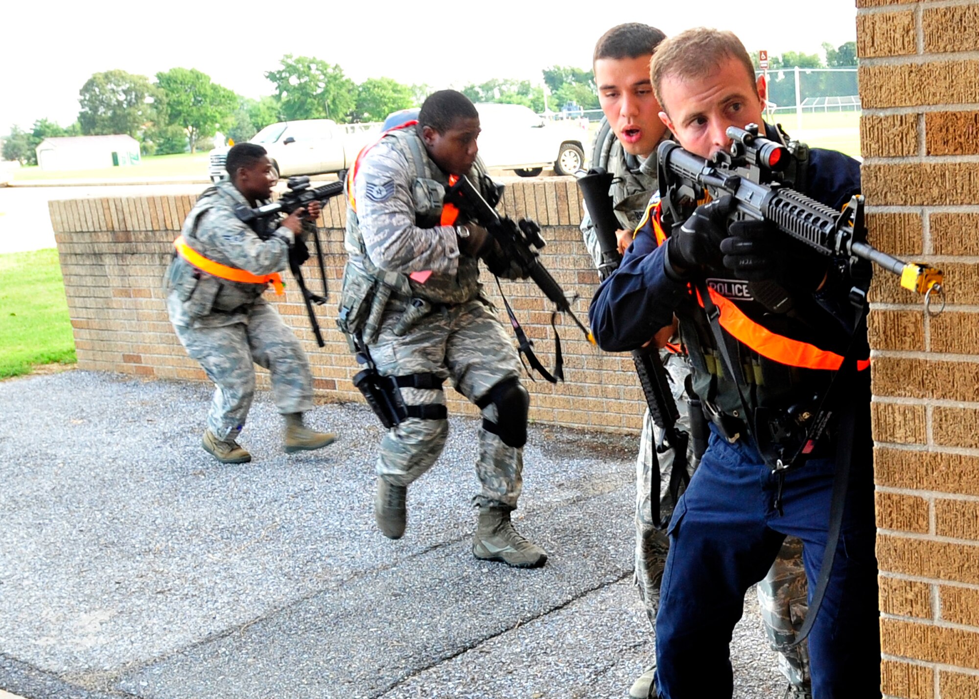 Members of a 436th Security Forces Squadron response team prepare to enter Major George S. Welch Elementary School Aug. 13, 2013, on Dover Air Force Base, Del. The members were responding to an active shooter scenario during the major accident response exercise. (U.S. Air Force photo/Tech. Sgt. Chuck Walker)