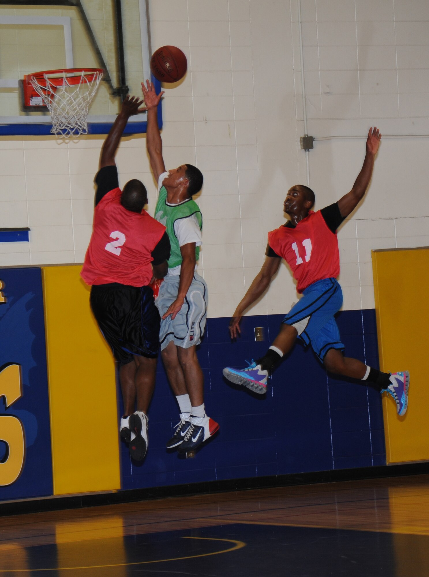 Vernon Peoples, 81st Communications Squadron, attempts to block a lay-up by Cameron King, 336th Training Squadron, during an intramural basketball game Aug. 19, 2013, at the Blake Fitness Center, Keesler Air Force Base, Miss. The 81st CS defeated the 336th TRS, 60-50.  (U.S. Air Force photo by Kemberly Groue)