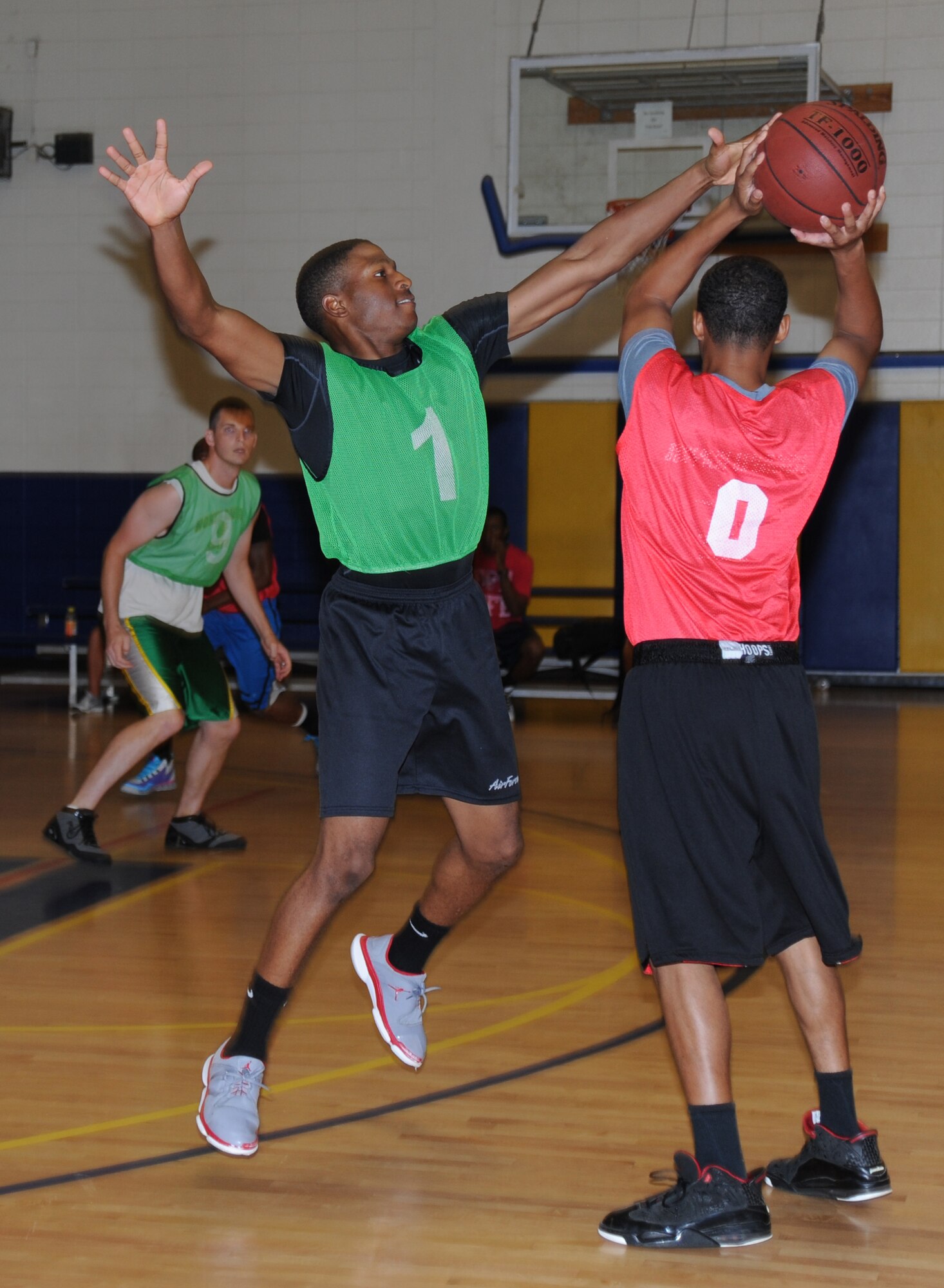 Aaron Blackmon, 336th Training Squadron, blocks as Jerreald Hickman, 81st Communications Squadron, attempts to pass the ball to a teammate during an intramural basketball game Aug. 19, 2013, at the Blake Fitness Center, Keesler Air Force Base, Miss. The 81st CS defeated the 336th TRS, 60-50.  (U.S. Air Force photo by Kemberly Groue)