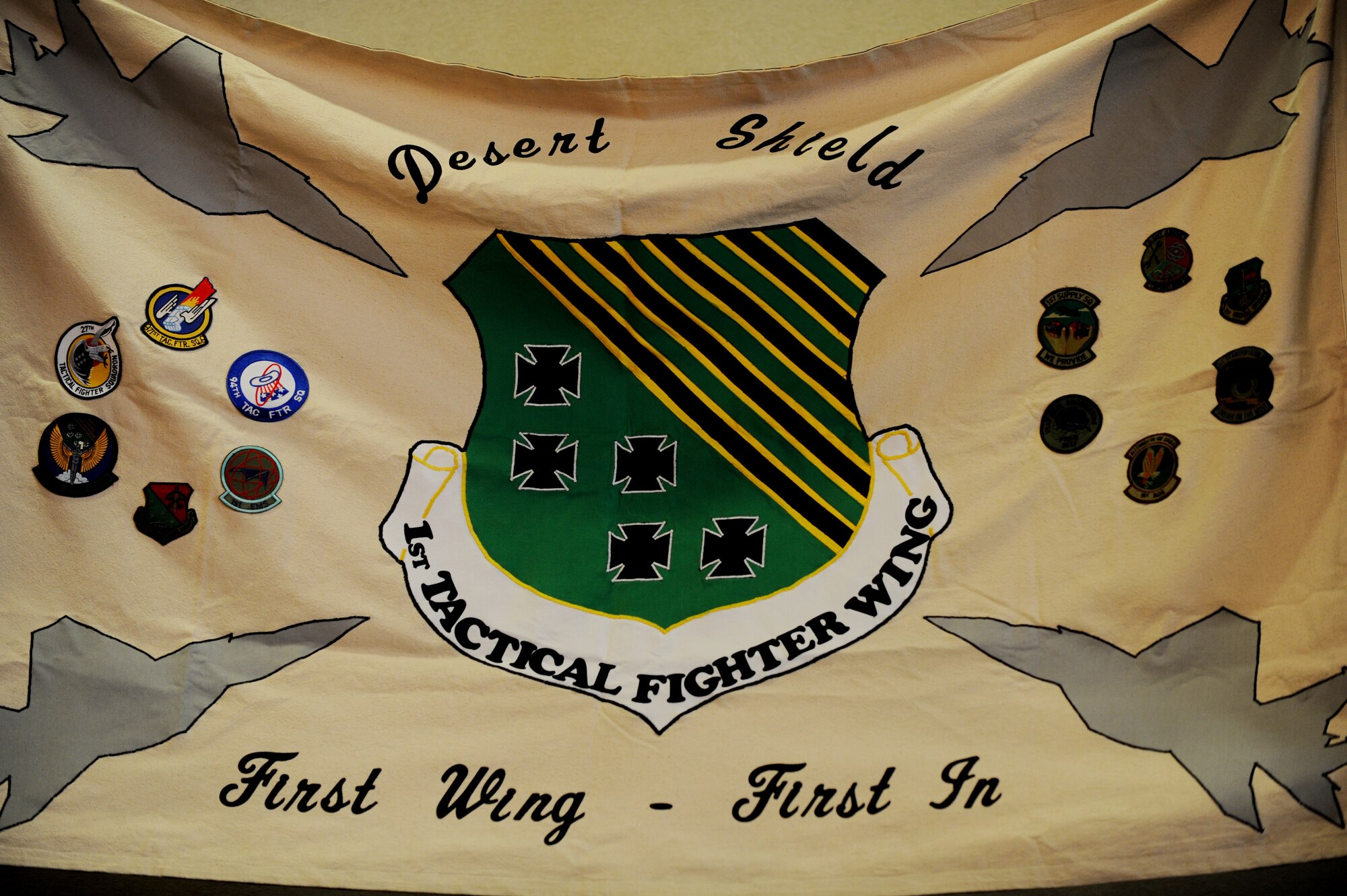 A flag, designed and created for the 1st Fighter Wing, is presented to Langley Air Force Base, Va. during the 1st Fighter Wing Association reunion, Aug. 16, 2013. The flag was created by spouses of pilots to symbolize the sacrifices of the Airmen who served as part of the 1st FW. (U.S. Air Force photo by Staff Sgt. Jarad A. Denton/Released)