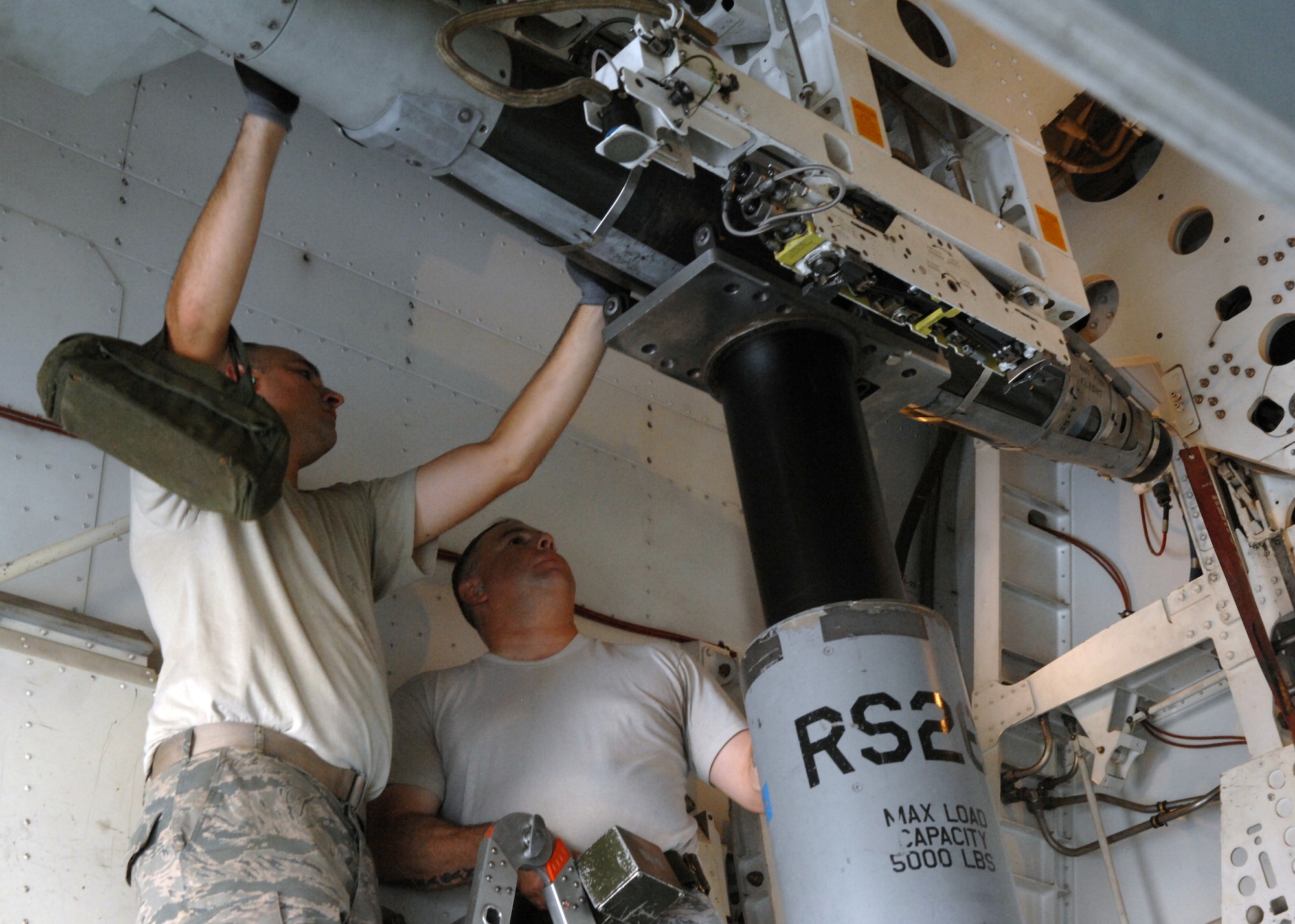 U.S. Air Force Staff Sgts. Andrew Eudey, left, and Lyle Eagan, 7th Munitions Squadron load crew members, load a GBU-54 on to a 10-carry bomb module on the B-1 during a practice load Aug. 8, 2013, on Dyess Air Force Base, Texas. Knowing the B-1’s weapons system is important because it is the load crew member’s job to understand the way the weapons work from start to finish. (U.S. Air Force photo by Senior Airman Shannon Hall/Released)