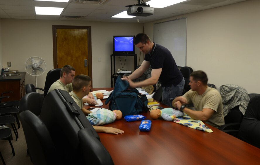 U.S. Air Force Staff Sgt. Matthew Williams, 9th Air Force intelligence analyst, teaches a Dads 101 course to Airmen at Shaw Air Force Base, S.C., July 19, 2013. The material taught is tailored to address men’s concerns about fatherhood. (U.S. Air Force photo by Airman 1st Class Jensen Stidham/Released)