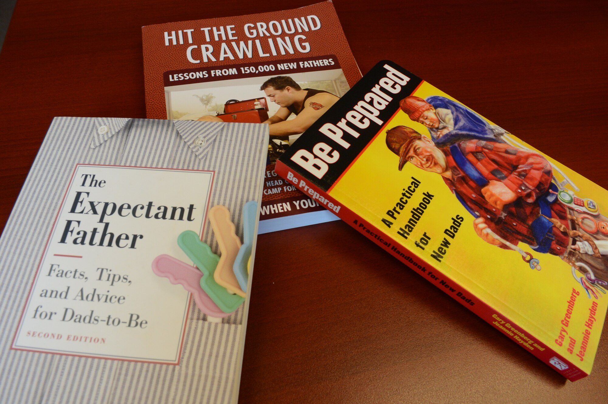 Three books the Dads 101 class uses as instructional aides sit on a table at Shaw Air Force Base, S.C., Aug. 1, 2013. Dads 101 is a class for new or expectant fathers who want to learn how to be a better father for their children. (U.S. Air Force photo by Airman 1st Class Jonathan Bass/Released)