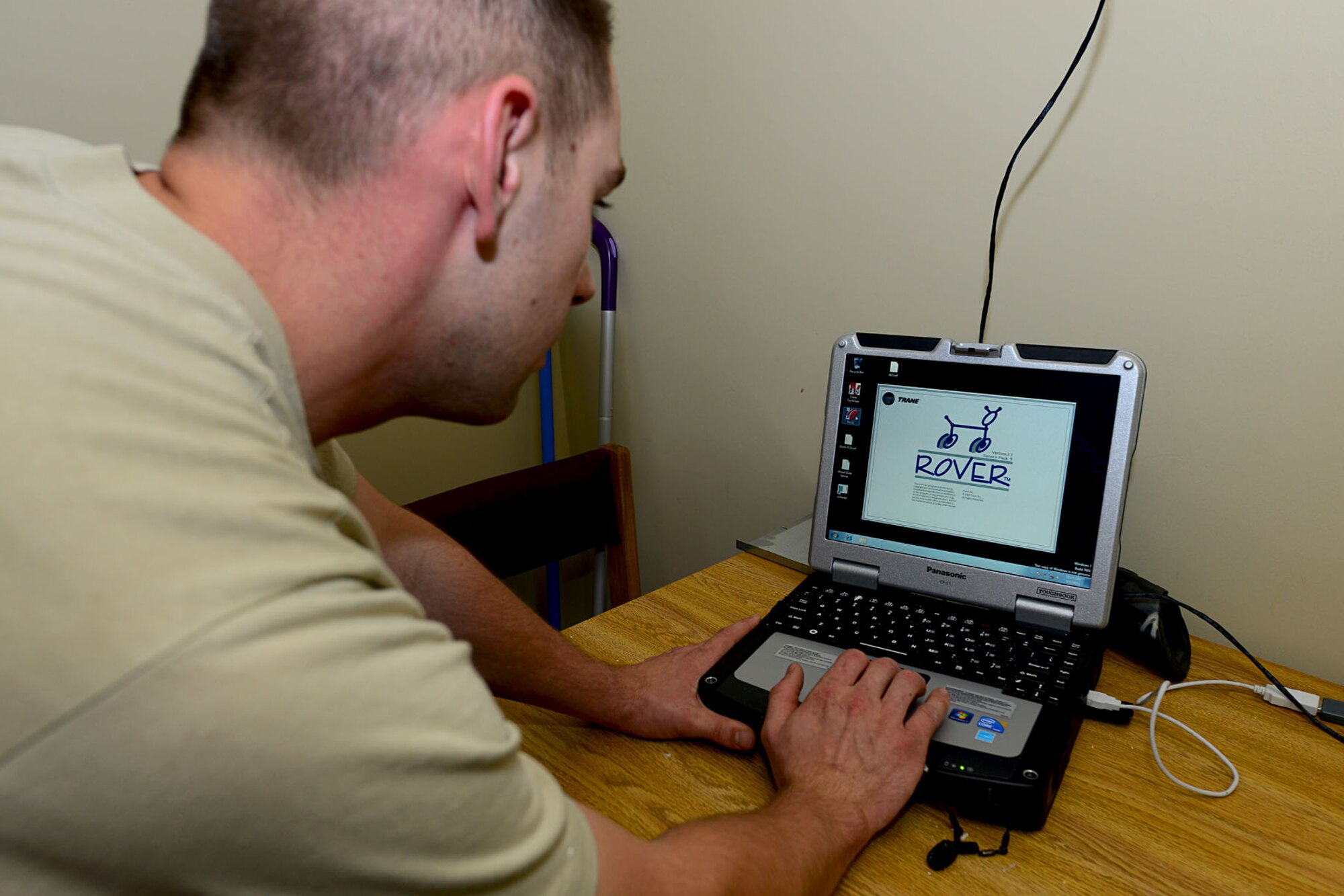 U.S. Air Force Staff Sgt. Jack Olney, 633rd Civil Engineer Squadron heating, ventilation and air conditioning craftsman, uses the Rover system to repair an air conditioning fan coil at Langley Air Force Base, Va., Aug. 16, 2013. The Rover system was introduced eight months ago as a direct digital control system used to repair HVAC units. (U.S. Air Force photo by Staff Sgt. Ashley Hawkins/Released)