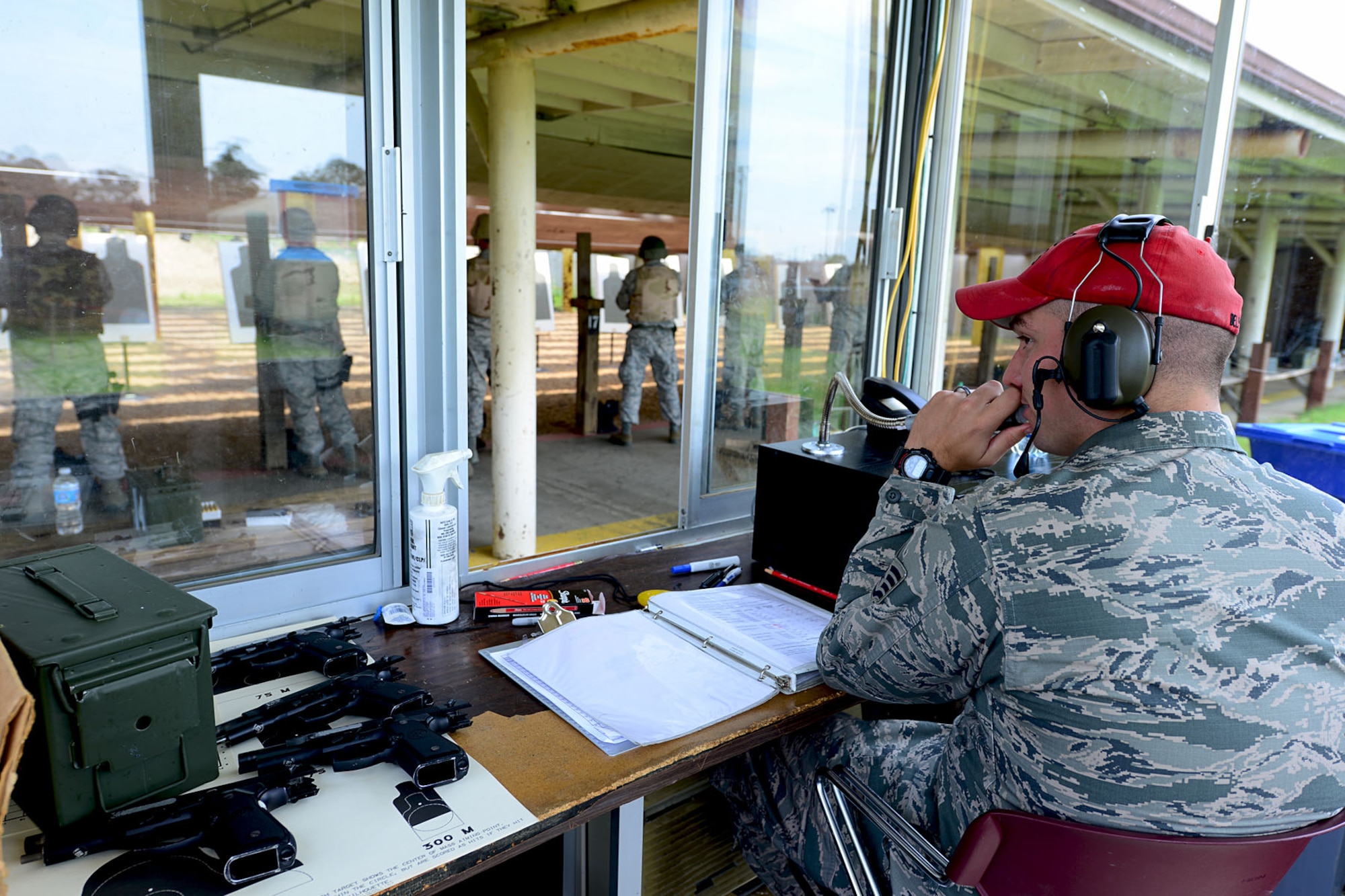 U.S. Air Force Staff Sgt. William Delphia, 633rd Security Forces Squadron combat arms training and maintenance instructor, explains firing procedures while on the CATM range at Langley Air Force Base, Va., Aug. 13, 2013. The CATM instructors teach weapons qualifications for various reasons such as Service members deploying and undergoing permanent change of station. (U.S. Air Force photo by Staff Sgt. Ashley Hawkins/Released)