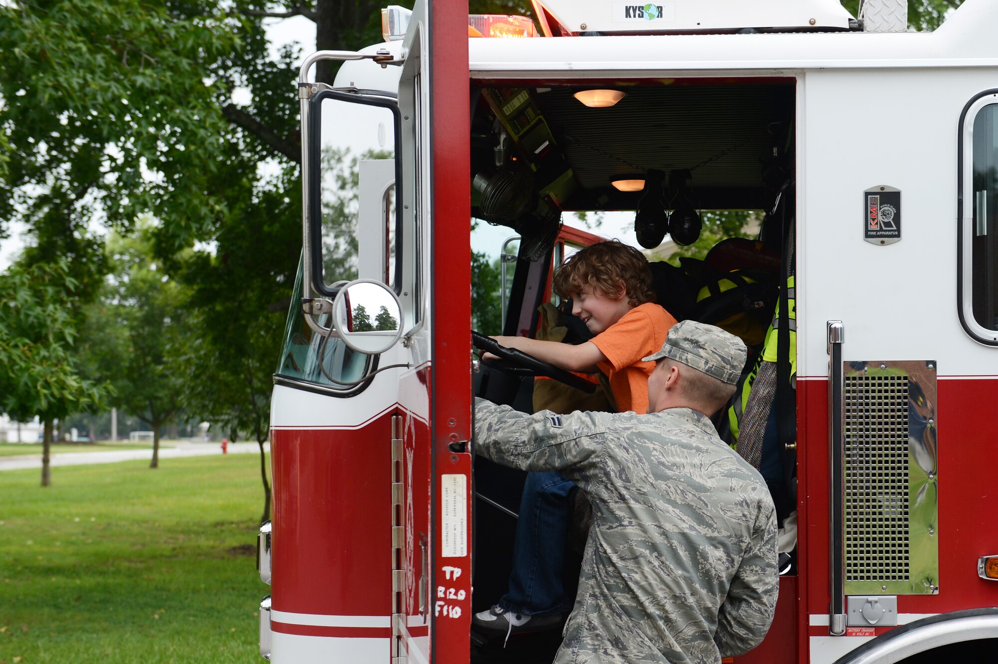 Aiden Boarts, son of Alicia Boarts, a military spouse, explores a 20th Civil Engineer Squadron fire emergency services fire engine that was displayed during the Child Find Clinic and Community Resource Awareness Fair at Shaw Air Force Base, S.C., Aug. 14, 2013. At the free annual fair there was also a bouncy castle, a Humvee display from Third Army/U.S. Army Central and booths by organizations that had services and resources to offer families with special needs. (U.S. Air Force photo by Airman 1st Class Krystal M. Jeffers/Released)