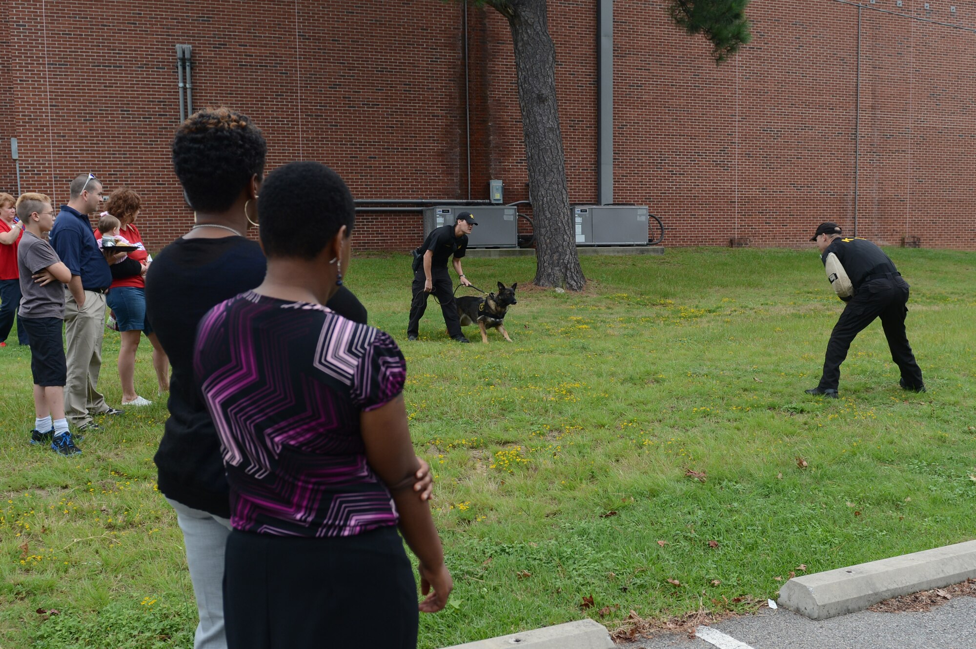 The Sumter County Sheriff’s Office holds a K-9 unit demonstration during the Child Find Clinic and Community Resource Awareness Fair at Shaw Air Force Base, S.C., Aug. 14, 2013. The free annual fair offered a variety of activities like a clinic that screened children for health deficiencies, a bouncy castle, a Humvee display from Third Army/U.S. Army Central and booths by organizations that had services and resources to offer families with special needs. (U.S. Air Force photo by Airman 1st Class Krystal M. Jeffers/Released)