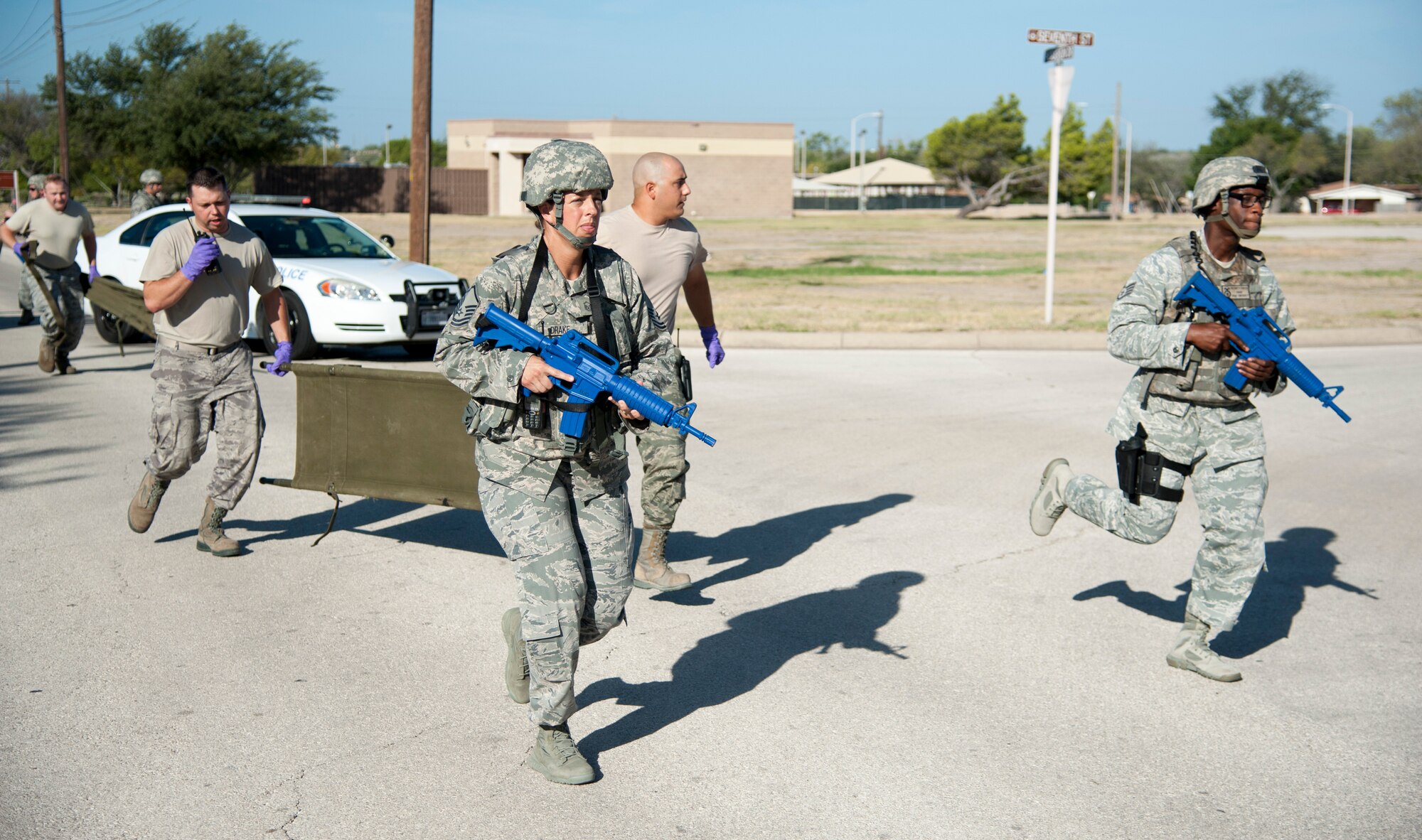 Members from the 47th Security Forces Squadron and the 47th Medical Group run towards an active shooter scenario at Laughlin Air Force Base, Texas, Aug. 14, 2013. Both organizations work together to improve communication and to familiarize each other with their procedures. (U.S. Air Force photo/Senior Airman John D. Partlow)
