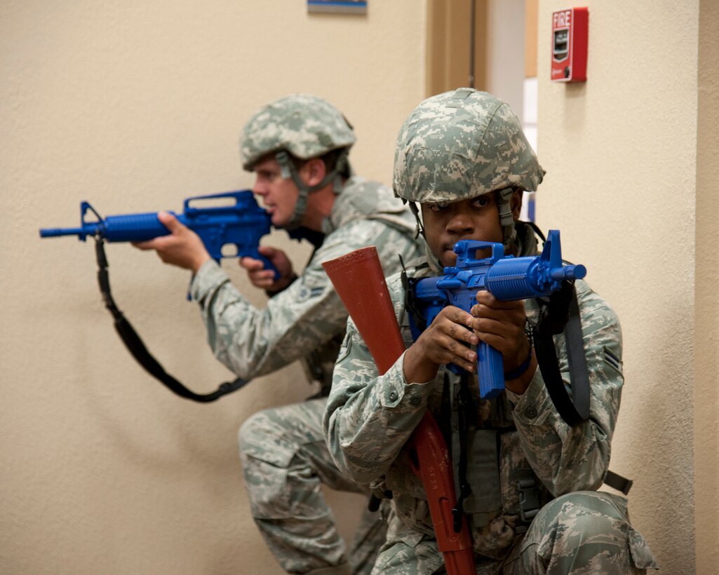 Airmen 1st Class Mark Walker Jr., left, and James Little III, both 47th Security Forces Squadron patrolmen, guard a door during an active shooter scenario at Laughlin Air Force Base, Texas, Aug. 14, 2013. Several 47th SFS members helped during the exercise to resolve the active shooter scenario as efficiently and expeditiously as possible. (U.S. Air Force photo/Senior Airman John D. Partlow)