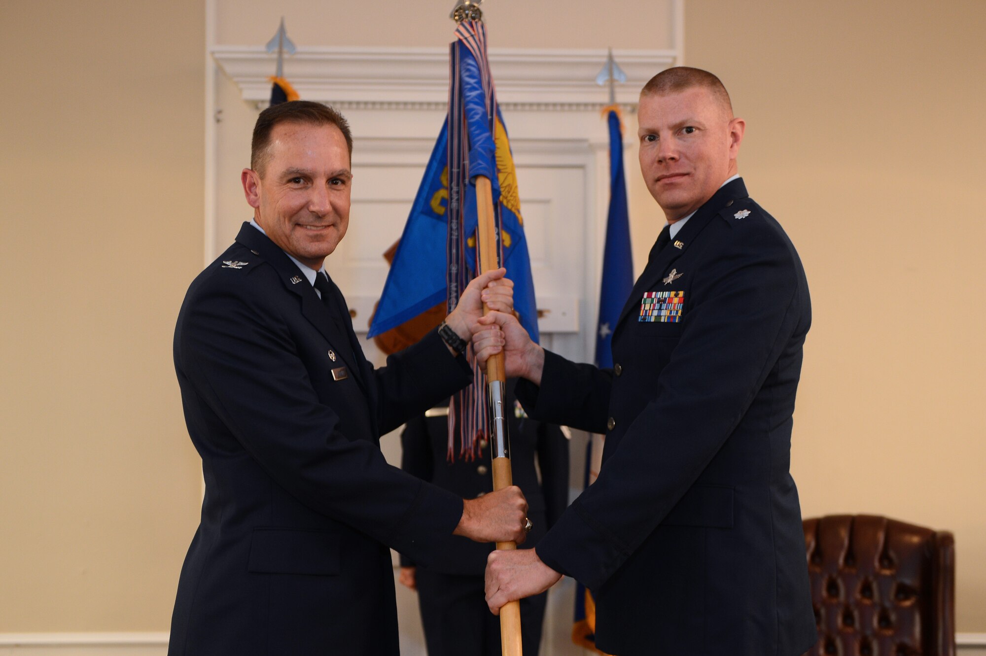 Col. Scott Arcuri (left), 20th Mission Support Group commander, hands the 20th Communications Squadron’s guidon to Lt. Col. David McKoy, during a change of command ceremony at Shaw Air Force Base, S.C., Aug. 14, 2013. The ceremony was held at the Carolinas Skies Club and Conference Center and was followed by a reception where Airmen could meet their squadron’s new commander. (U.S. Air Force photo by Airman 1st Class Daniel Blackwell/Released)