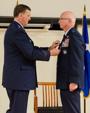 Brig. Gen. Mark Kraus (right), a Kentucky Air National Guardsman who serves as Air National Guard assistant to the commander of U.S. Air Forces Central, is awarded The Legion of Merit, first oak leaf cluster, by Kentucky’s adjutant general, Maj. Gen. Edward Tonini, during a ceremony held Aug. 18, 2013, at the Kentucky Air National Guard Base in Louisville, Ky. Kraus also was promoted to the rank of major general during the ceremony. (U.S. Air National Guard photo by Airman Joshua Horton)