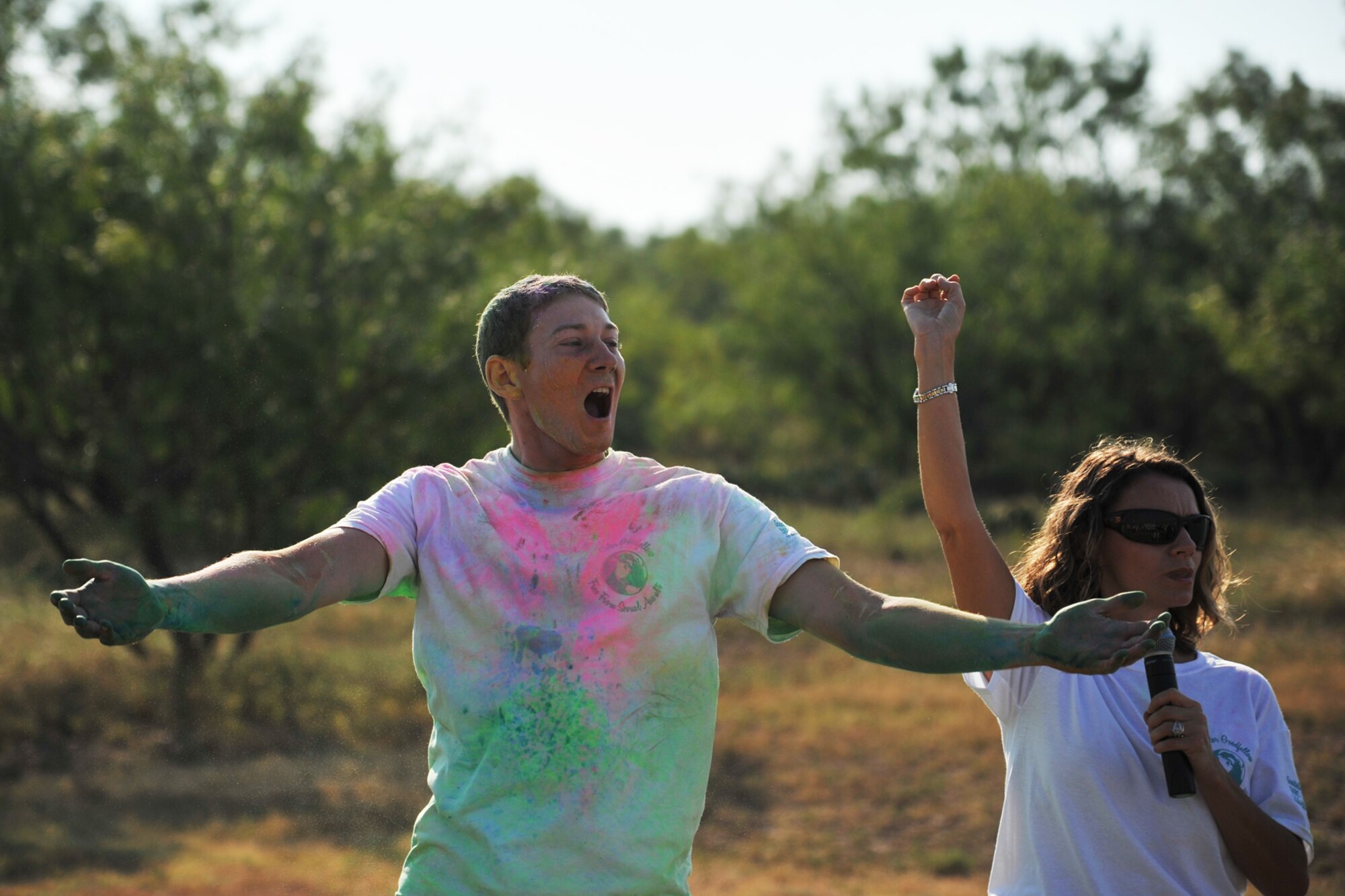 GOODFELLOW AIR FORCE BASE, Texas-- Airman 1st Class Jacob Elmiger, 312th Training Squadron student, yells to pump up the crowd at the Sexual Assault Prevention and Response Color Race messiest person contest on Kiowa Trail Aug 17. The crowd was given the chance to vote for the messiest person by making as much noise as the contestants were presented. (U.S. Air Force photo/ Senior Airman Michael Smith) 
