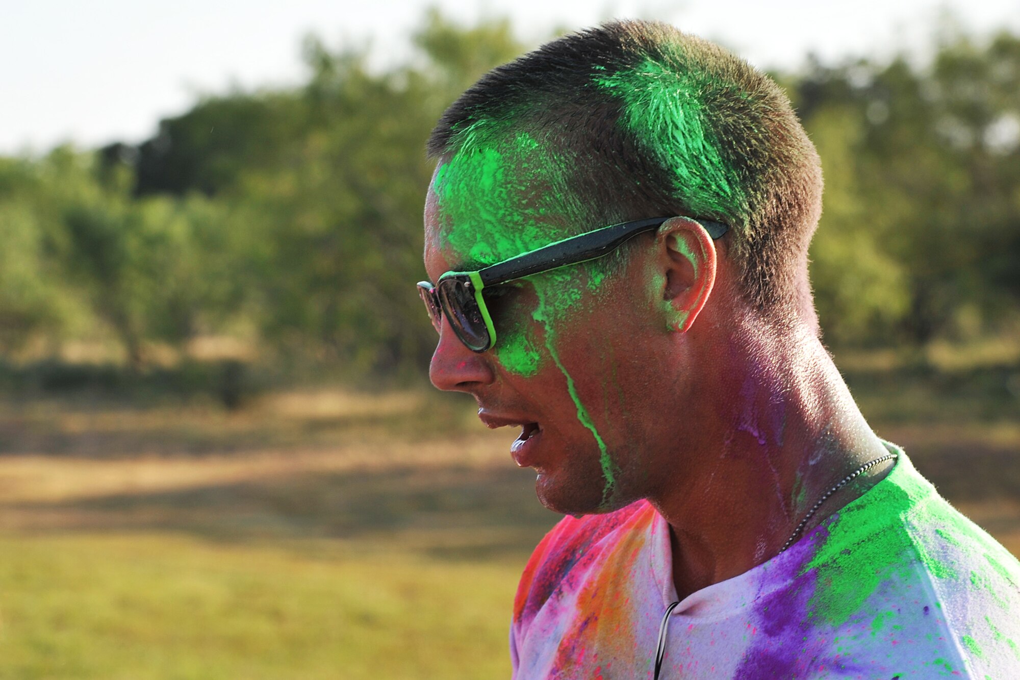 GOODFELLOW AIR FORCE BASE, Texas-- Airman 1st Class Jared Wells, 315th Training Squadron student, catches his breath after finishing the Sexual Assault Prevention and Response Color Race on Kiowa Trail Aug 17. Each participant of the race ran through several color stations where colored powder would be thrown. (U.S. Air Force photo/ Senior Airman Michael Smith) 