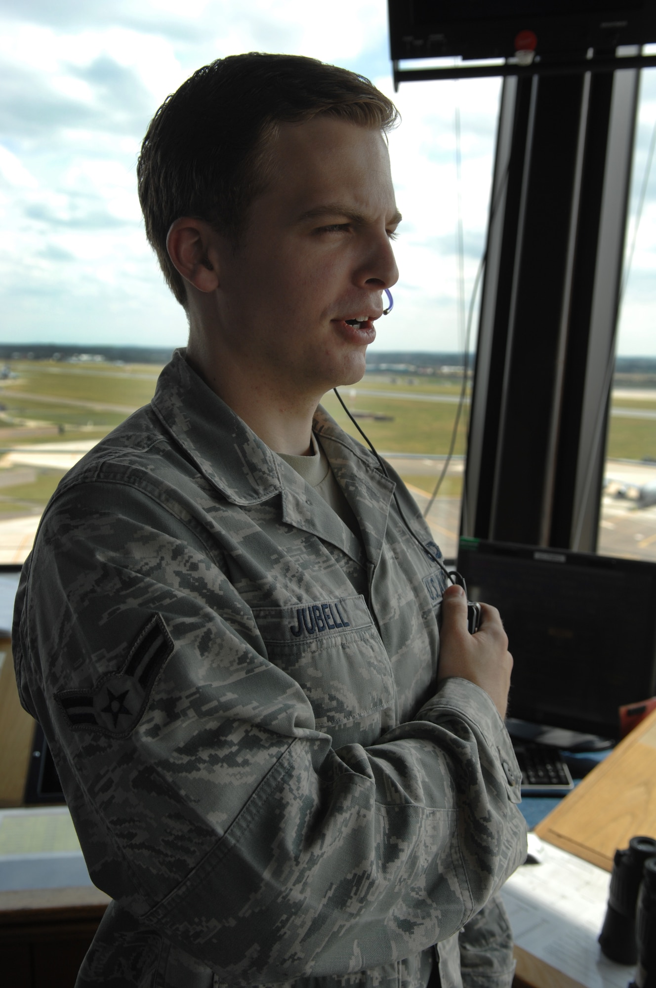U.S. Air Force Airman 1st Class Wolfgang Jubell, 100th Operations Support Squadron air traffic controller, uses a headset to guide an aircraft to a landing Aug. 7, 2013, on RAF Mildenhall, England. Tower controllers guide aircraft by sight as long as there is clear visibility. In times of low visibility, controllers rely on radar to get planes home safely. (U.S. Air Force photo by Airman 1st Class Dillon Johnston/Released) 