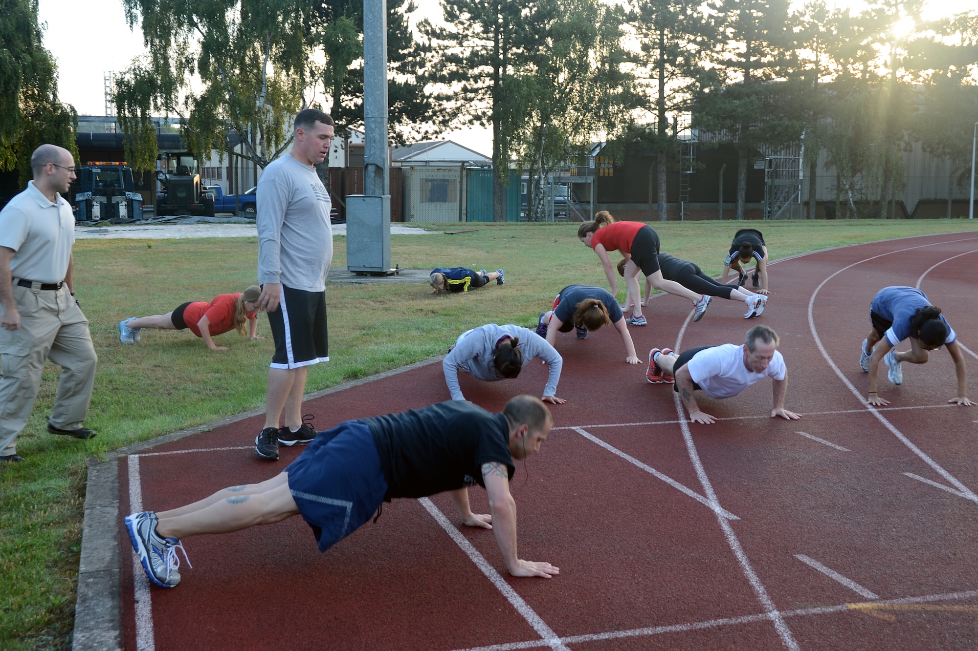 Participants of the RAF Lakenheath Health and Wellness Center’s High Intensity Interval Training class do push-ups Aug. 7, 2013. H.I.I.T. is a free 30-minute program designed to improve muscular endurance in a fast-paced, total-body workout.  (U.S. Air Force photo by Trevor T. McBride/Released)           