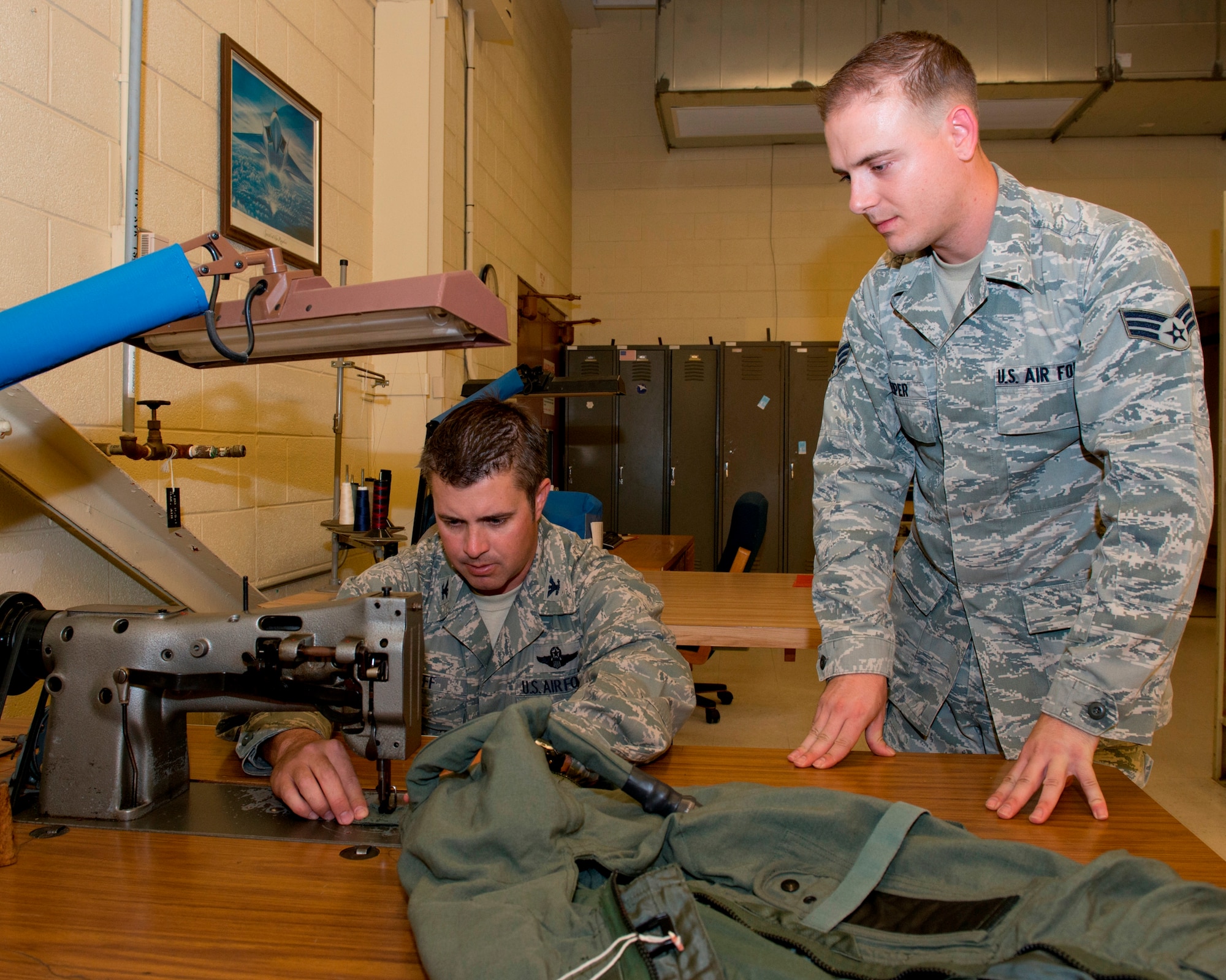 Colonel David E. Graff, 325th Fighter Wing commander, uses a sewing machine on an anti-G suit while he shadows Senior Airman Brandon Keiper, 325th Operations Support Squadron aircrew flight equipment technician, Aug 16. The program provides an opportunity for the commander to get a first-hand look at what Tyndall Airmen are doing. 
 (U.S. Air Force photo by Lisa Norman) 
