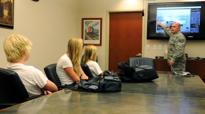 Technical Sgt. Jeremy Giacoletto-Stegall, photographer with the 151st Public Affairs office in Salt Lake City, reviews an image from the latest assignment with students on August 6, 2013, in Draper, Utah. Stegall intructs a class for local teenagers weekly at the Draper City Hall.(U.S. Air Force photograph by Senior Master Sgt. Gary J. Rihn)(RELEASED)