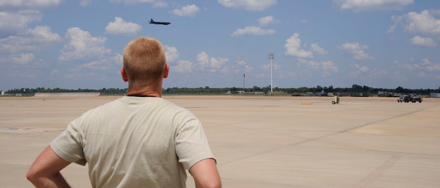 Senior Airman Nicholas Kupferle, 96th Aircraft Maintenance Unit, watches a B-52H Stratofortress prepare to land on Barksdale Air Force Base, La., Aug. 19. For the past 60 years, the B-52 has provided long-range bombing capability and is capable of launching the widest array of weapons in the U.S. arsenal. (U.S. Air Force photo/Airman 1st Class Andrew Moua)