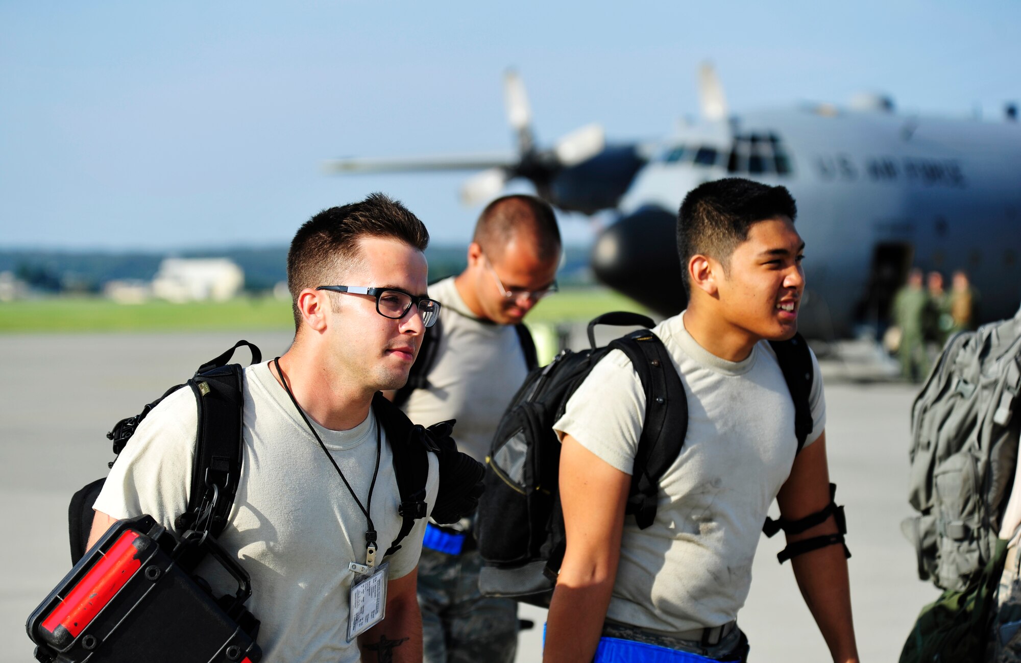 Airmen with the 374th Aircraft Maintenance Squadron walk off the flightline after a day of work Aug. 17, 2013, Yokota Air Base, Japan. The maintainers were responsible for preparing a C-130 Hercules for a large formation Aug. 19, 2013. (U.S. Air Force photo by Senior Airman Cody H. Ramirez)