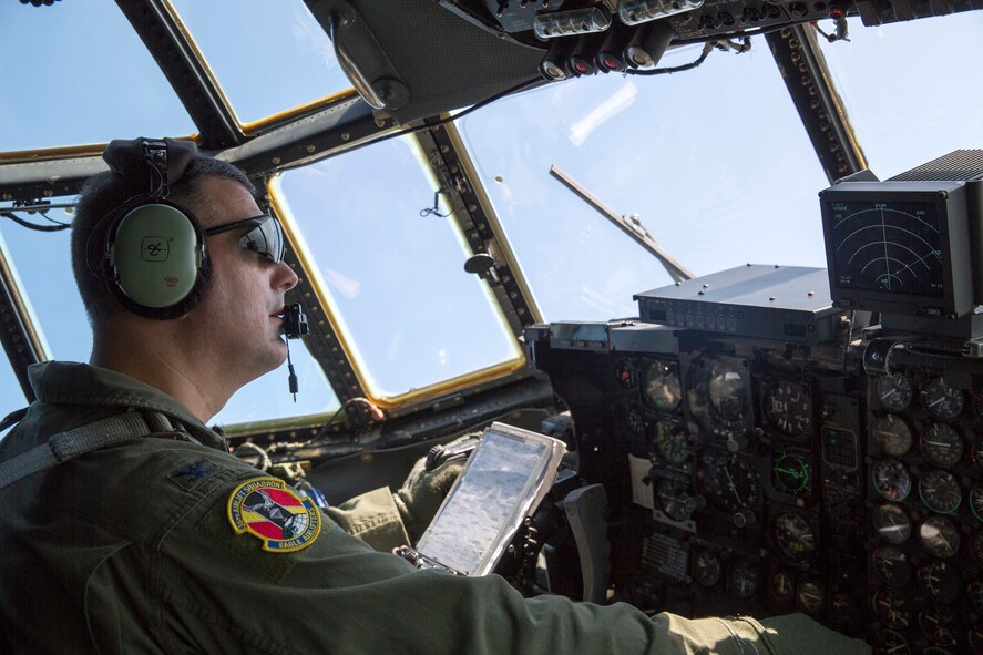 ABOVE KANTO PLAIN, Japan -- Col. Mark August, 374th Airlift Wing commander, performs visual identification of another C-130 Hercules above the Kanto Plain, Aug. 19, 2013. The C-130 aircrews demonstrated their airlift capabilities during a large formation surge flight. (U.S. Air Force photo by Osakabe Yasuo)  