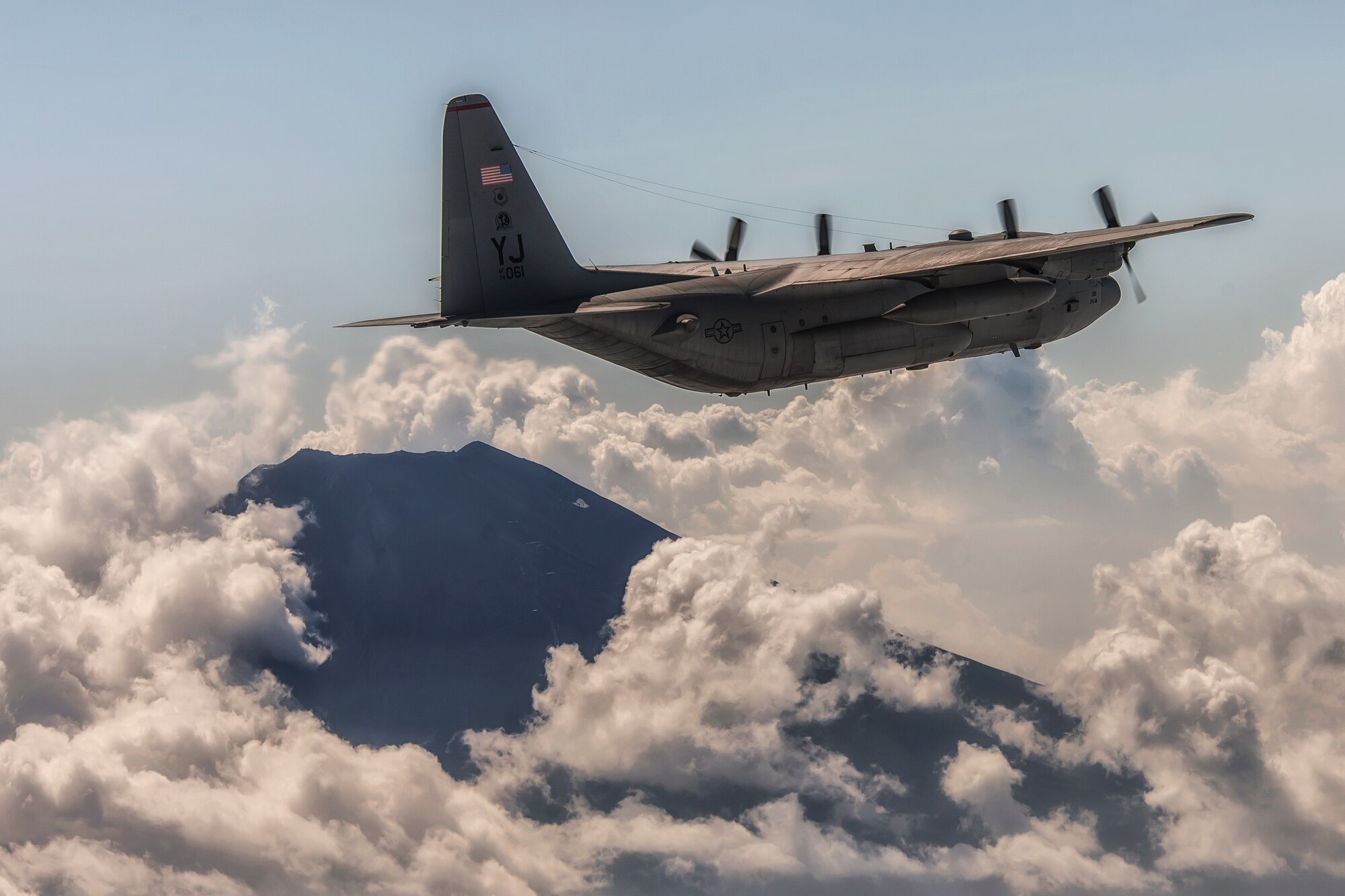 NEAR MOUNT FUJI, Japan -- A C-130 Hercules performs a training mission near Mount Fuji, Japan, Aug. 19, 2013, during a large formation surge flight. Seven C-130s flew in formation practicing airlift tactics and procedures. (U.S. Air Force photo by Osakabe Yasuo)