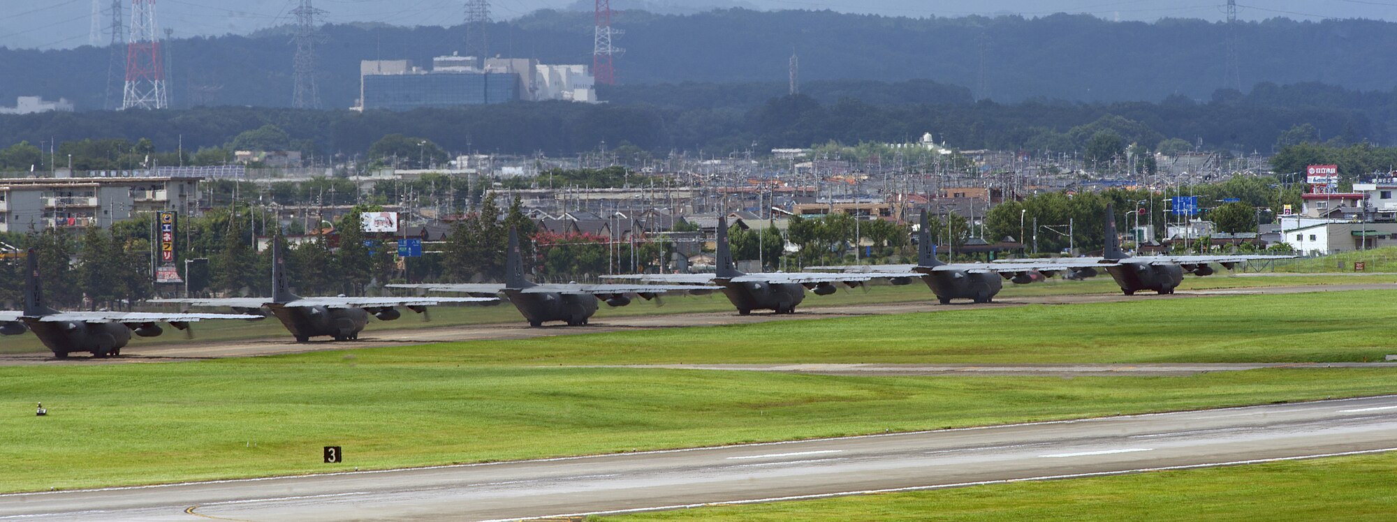 YOKOTA AIR BASE, Japan – Six C-130 Hercules from the 374th Airlift Wing taxi into position as they prepare to take off as part of a large formation training mission at Yokota Air Base, Japan, Aug. 19, 2013.  The wing conducts surge operations to test its capability to prepare and launch multiple aircraft at the same time, highlighting Yokota’s mission as the primary Western Pacific airlift hub for peacetime and contingency operations.  (U.S. Air Force photo by Tech. Sgt. Christopher Marasky)