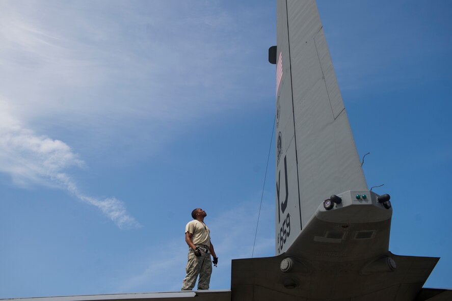 Tech. Sgt. Reginald Grisby inspects a C-130 Hercules’ tail Aug. 17, 2013, at Yokota Air Base, Japan. Grisby is a dedicated flying crew chief with the 374th Aircraft Maintenance Squadron. (U.S. Air Force photo by Senior Airman Cody H. Ramirez)