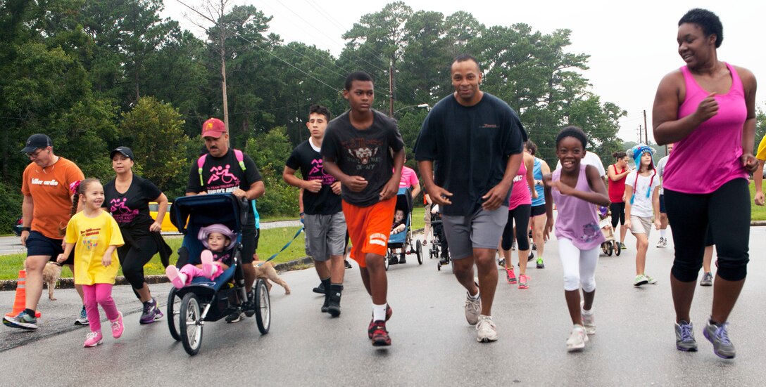 Families begin running in the Funny Sunny Hat Run at the Tarawa Terrace Community Center, Aug. 17.  The run was a two-mile course with a three-mile option through the streets of Tarawa Terrace, a housing area of Marine Corps Base Camp Lejeune.