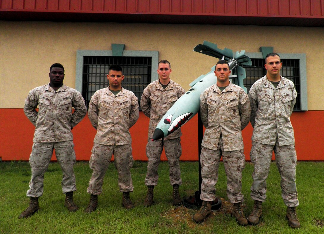 (From left) U.S. Marine Corps lance corporals Detrick Milton, Brandon Hodges, Adam Donahue, Brent Nelson, and Cpl. Zachariah Riley, rushed to the aid of a motorist trapped inside a cargo truck June 7 after witnessing the fully-loaded truck take a turn too fast, roll-over and skid off the road near Chinhae, South Korea. The Marines from the U.S. Marine Corps Forces Korea Aviation Ordinance Detachment cut the seatbelt to free the trapped driver, moved him to safety and performed first aid to treat profuse bleeding and other injuries. (U.S. Marine Corps photo by Capt. Brad Wilde)