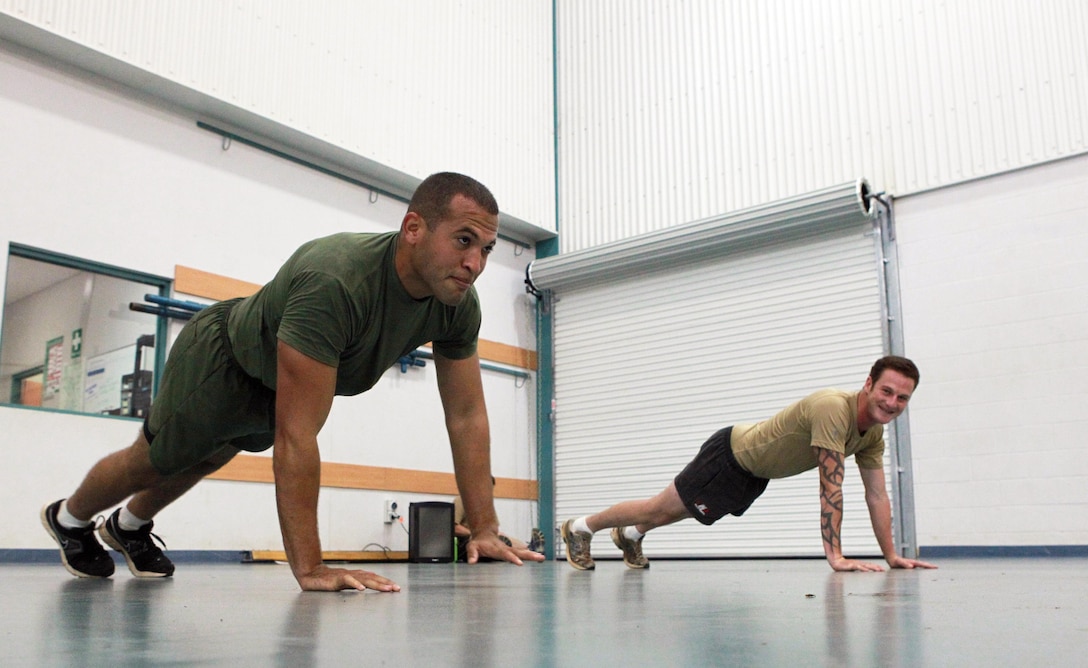 Cpl. Luis Vasquez, automotive mechanic, Lima Company, 3rd Battalion, 3rd Marine Regiment, Marine Rotational Force - Darwin, and an Australian Army classmate, complete moving pushups during a Combat Fitness Leadership Course physical training session at the Northern Gym, here, Aug. 20. The course teaches students to lead physical training techniques. Two MRF-D Marines are attending the month-long course. This is the first time Marines have participated in an Australian Army training course here.
