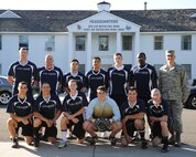 Members of the Fairchild Air Force Base soccer team pose for a photo with Col. Brian Newberry, 92nd Air Refueling Wing commander, in front of the Wing headquarters building at Fairchild Aug. 20, 2013. The team practices every Tues. and Thurs. at 5 p.m. and is always looking to add players to their roster. (U.S. Air Force photo by Airman 1st Class Janelle Patino)