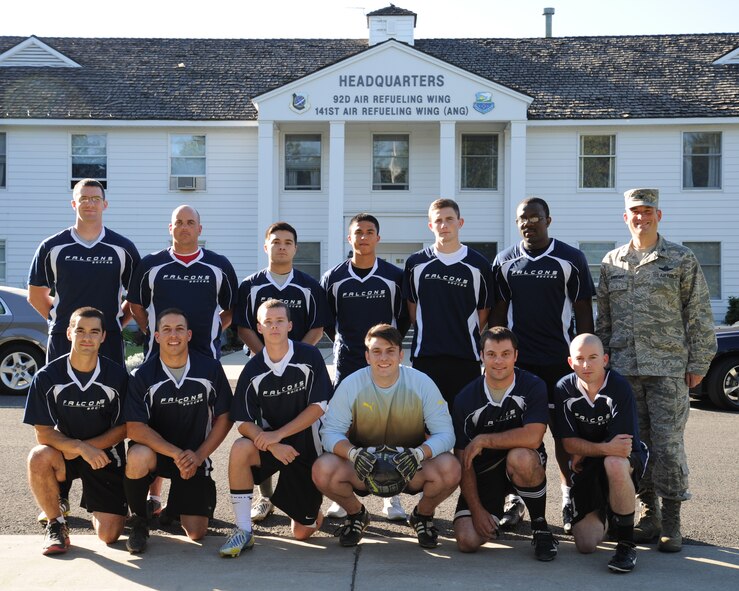 Members of the Fairchild Air Force Base soccer team pose for a photo with Col. Brian Newberry, 92nd Air Refueling Wing commander, in front of the Wing headquarters building at Fairchild Aug. 20, 2013. The team practices every Tues. and Thurs. at 5 p.m. and is always looking to add players to their roster. (U.S. Air Force photo by Airman 1st Class Janelle Patino)