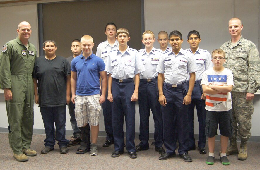 Cadets with the Enid Civil Air Patrol Composite Squadron pose with Col. Darren James, the 71st Flying Training Wing commander, far left, and Lt. Col. David Woodley, the 71st Operations Support Squadron commander, far right, during an Aug. 5 CAP meeting on base. (Courtesy photo)
