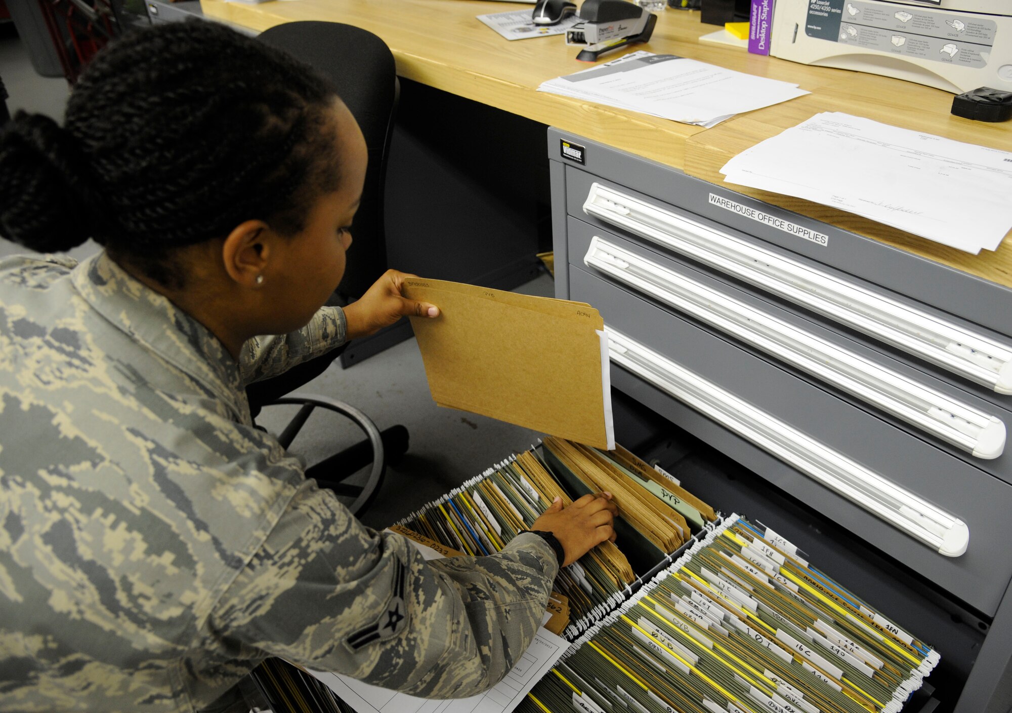 Airman 1st Class Alyssa Boose, 2nd Medical Support Squadron medical logistics technician, files inventory records on Barksdale Air Force Base, La., Aug. 21, 2013. Medical logistics Airmen keep records to track equipment and supplies coming in and out of the warehouse. (U.S. Air Force photo/Airman 1st Class Andrew Moua)
