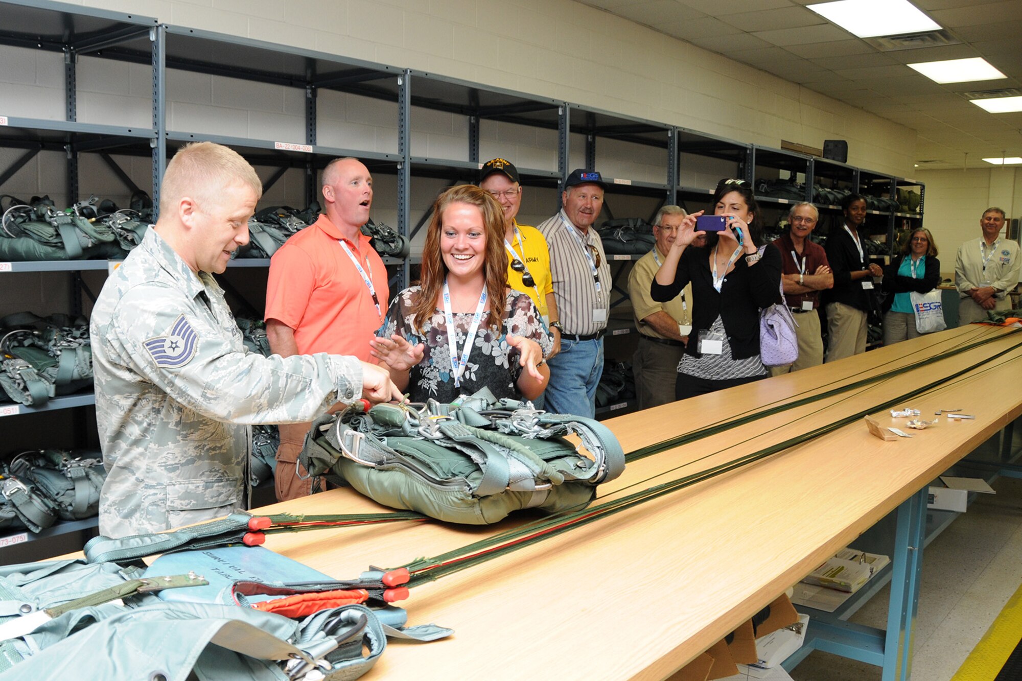 YOUNGSTOWN AIR RESERVE STATION, Ohio – Air Force Reserve Tech. Sgt. Ed Peggs, an Aircrew Flight Equipment technician assigned to the 910th Operations Support Squadron, shows a packed parachute to an employer here, August 2, 2013. The group of employers attended the inaugural Joint Employer Awareness Event, co-hosted by the 910th, the Ohio National Guard and Ohio ESGR. The two-day event gave employers of Air Force Reservists and Guardsmen the opportunity to get an up-close look at both Camp Ravenna and YARS. The event also gave the employers a better understanding of the mission that their employees carry out as members of the U.S. Armed Forces. U.S. Air Force photo by Senior Airman Rachel Kocin