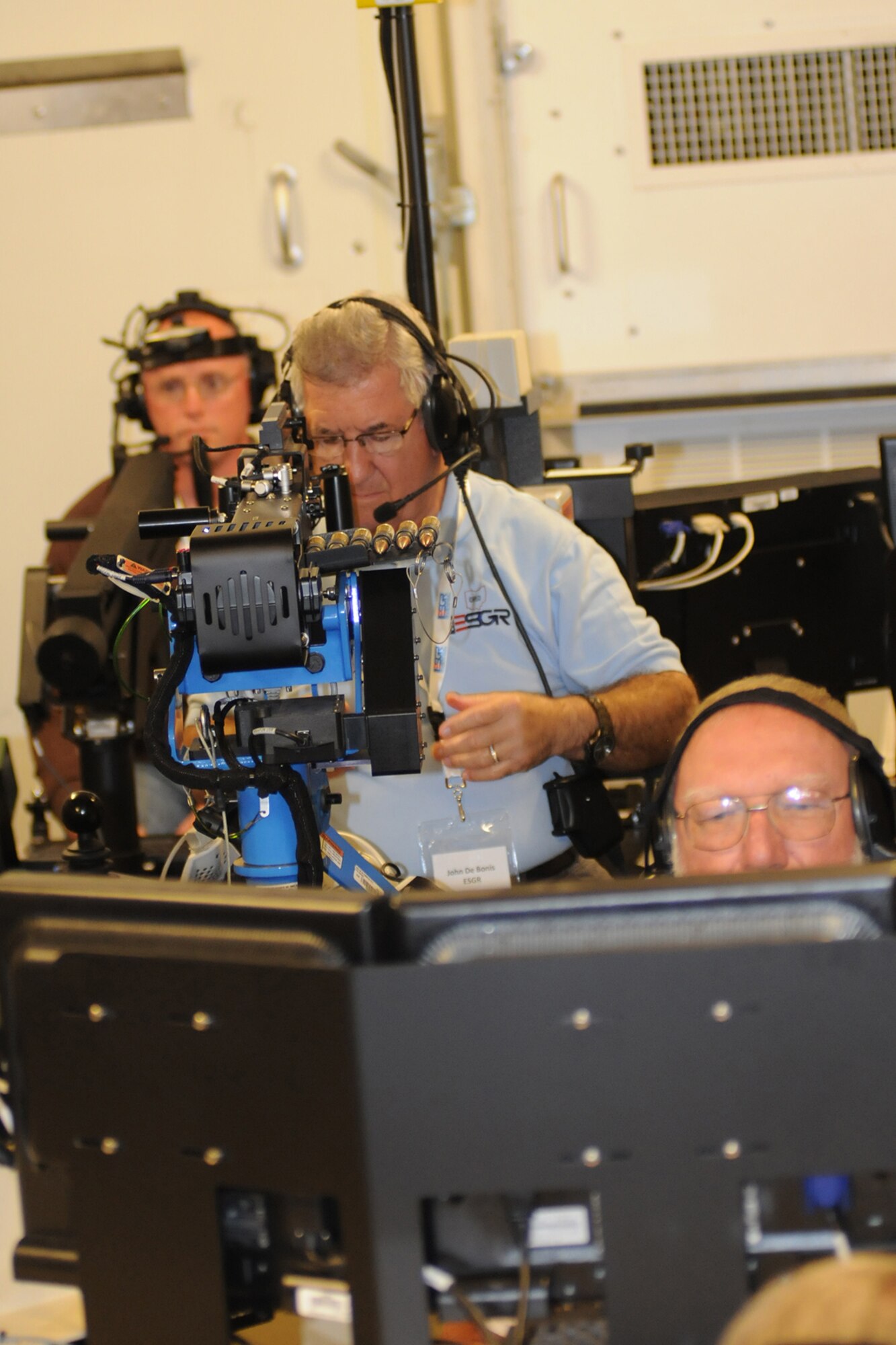 CAMP RAVENNA, Ohio -- John De Bonis, East Regional Director for Ohio Employer Support of the Guard and Reserve (ESGR), readies his 50 caliber machine gun at the Virtual Convoy Operations Trainer here, August 1, 2013. De Bonis attended the inaugural Joint Employer Awareness Event, co-hosted by the 910th, the Ohio National Guard and Ohio ESGR. The two-day event gave employers of Air Force Reservists and Guardsmen the opportunity to get an up-close look at both Camp Ravenna and YARS. The event also gave the employers a better understanding of the mission that their employees carry out as members of the U.S. Armed Forces. U.S. Air Force photo by Tech. Sgt.  James Brock 