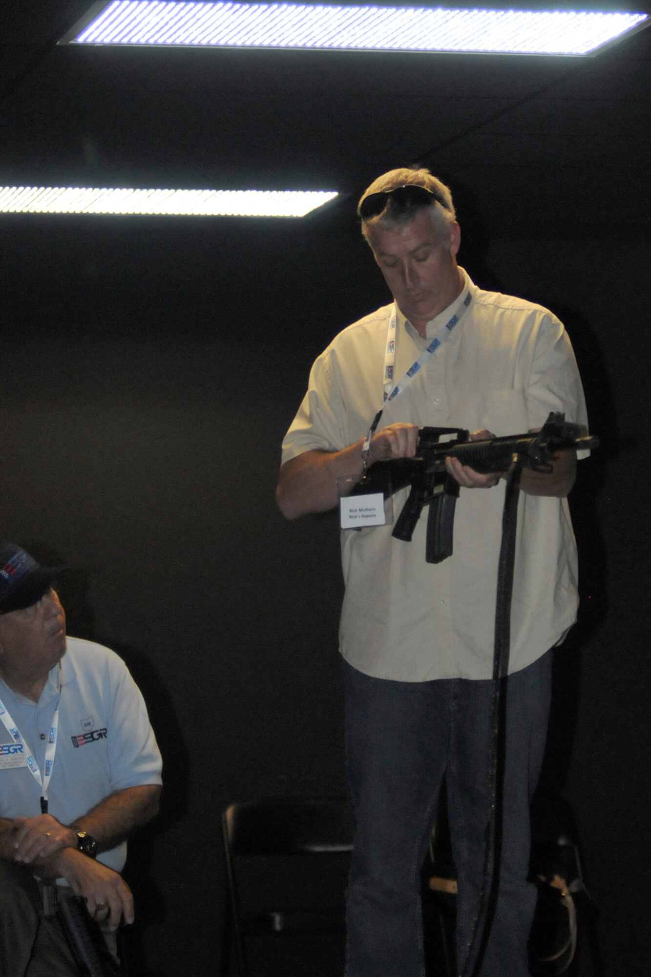 CAMP RAVENNA, Ohio -- Rick Mulhern, the owner of Rick’s Repairs, checks his M4 carbine at the firing range simulator here, August 1, 2013. Mulhern, the employer of an Air Force Reservist assigned to the 910th Airlift Wing, based at nearby Youngstown Air Reserve Station (YARS), Ohio attended the inaugural Joint Employer Awareness Event, co-hosted by the 910th, the Ohio National Guard and Ohio Employer Support of the Guard and Reserve (ESGR). The two-day event gave employers of Air Force Reservists and Guardsmen the opportunity to get an up-close look at both Camp Ravenna and YARS. The event also gave the employers a better understanding of the mission that their employees carry out as members of the U.S. Armed Forces. U.S. Air Force photo by Tech. Sgt.  James Brock
