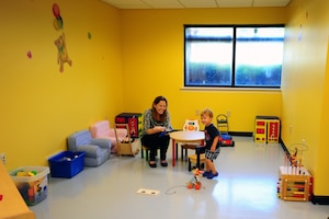 Rebecca Avey, 628th Medical Group Teddy's Child Watch trainer, plays with one year old Maxwell Shaw, son of Tech. Sgt. Michael Shaw, 437th Aerial Port Squadron cargo processing supervisor, while Maxwell's mom went to a medical appointment, Aug. 20, 2013 at JB Charleston- Air Base, S.C. Teddy's Child Watch provides short-term staff supervision to well children ages six weeks through 11 years old. The purpose of Teddy's is to help alleviate the stress of parents and guardians trying to find child care during medical appointments. You can assure that their child's health, safety and well-being are protected. (U.S. Air Force photo/ Airman 1st Class Chacarra Neal)
