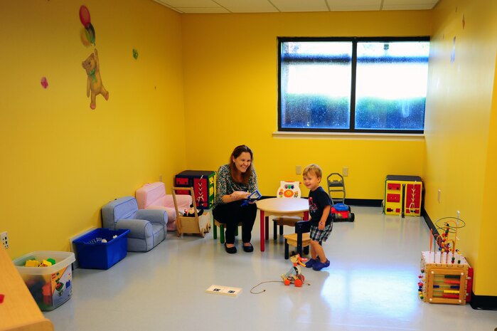 Rebecca Avey, 628th Medical Group Teddy's Child Watch trainer, plays with one year old Maxwell Shaw, son of Tech. Sgt. Michael Shaw, 437th Aerial Port Squadron cargo processing supervisor, while Maxwell's mom went to a medical appointment, Aug. 20, 2013 at JB Charleston- Air Base, S.C. Teddy's Child Watch provides short-term staff supervision to well children ages six weeks through 11 years old. The purpose of Teddy's is to help alleviate the stress of parents and guardians trying to find child care during medical appointments. You can assure that their child's health, safety and well-being are protected. (U.S. Air Force photo/ Airman 1st Class Chacarra Neal)