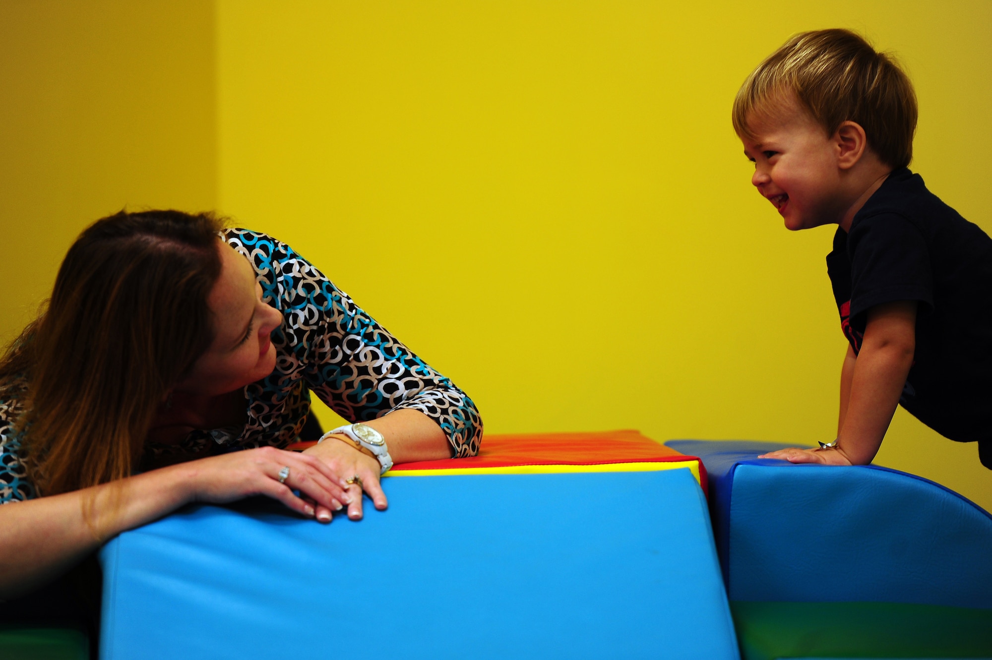Rebecca Avey, 628th Medical Group Teddy's Child Watch trainer, plays with one year old Maxwell Shaw, son of Tech. Sgt. Michael Shaw, 437th Aerial Port Squadron cargo processing supervisor, while Maxwell's mom went to a medical appointment, Aug. 20, 2013 at JB Charleston- Air Base, S.C. Teddy's Child Watch provides short-term staff supervision to well children ages six weeks through 11 years old. The purpose of Teddy's is to help alleviate the stress of parents and guardians trying to find child care during medical appointments. You can assure that their child's health, safety and well-being are protected. (U.S. Air Force photo/ Airman 1st Class Chacarra Neal)
