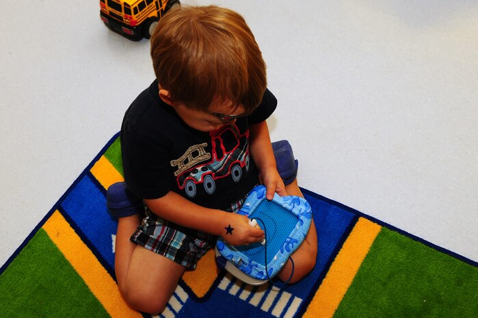 One year old Maxwell Shaw, son of Tech. Sgt. Michael Shaw, 437th Aerial Port Squadron cargo processing supervisor, plays at the Joint Base Charleston medical group's Teddy's Child Watch center while his mom went to a medical appointment, Aug. 20, 2013 at JB Charleston- Air Base, S.C. Teddy's Child Watch provides short-term staff supervision to well children ages six weeks through 11 years old. The purpose of Teddy's is to help alleviate the stress of parents and guardians trying to find child care during medical appointments. You can assure that their child's health, safety and well-being are protected. (U.S. Air Force photo/ Airman 1st Class Chacarra Neal)