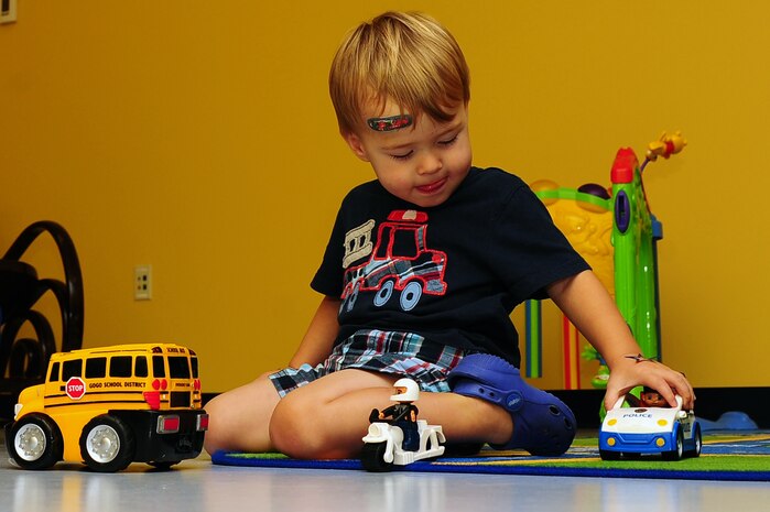 One year old Maxwell Shaw, son of Tech. Sgt. Michael Shaw, 437th Aerial Port Squadron cargo processing supervisor, plays at the Joint Base Charleston medical group's Teddy's Child Watch center while his mom went to a medical appointment, Aug. 20, 2013 at JB Charleston- Air Base, S.C. Teddy's Child Watch provides short-term staff supervision to well children ages six weeks through 11 years old. The purpose of Teddy's is to help alleviate the stress of parents and guardians trying to find child care during medical appointments. You can assure that their child's health, safety and well-being are protected. (U.S. Air Force photo/ Airman 1st Class Chacarra Neal)