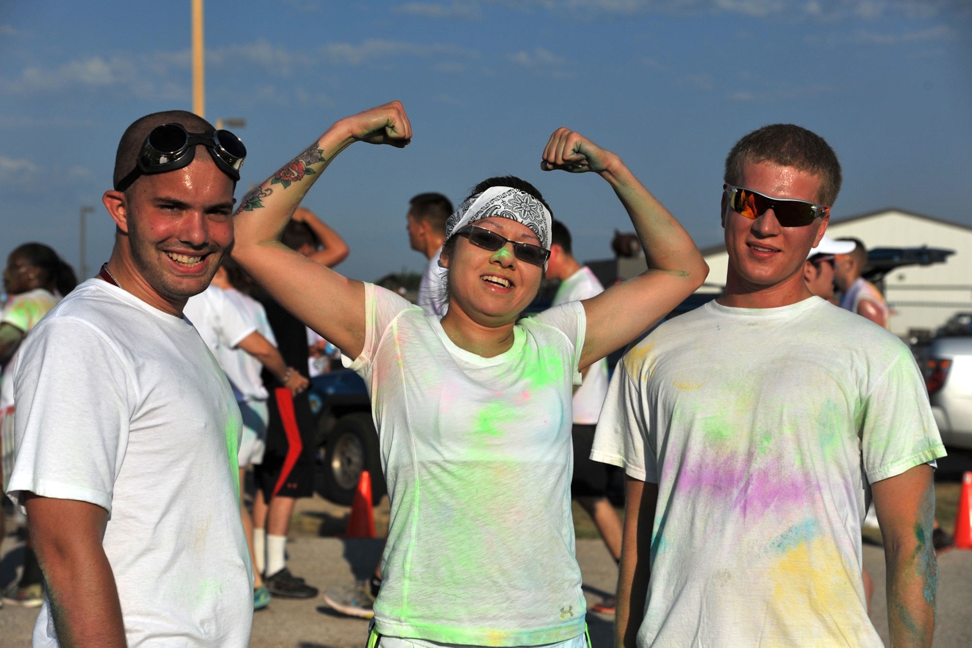 GOODFELLOW AIR FORCE BASE, Texas-- Airman 1st Class Jared Lunstad, 17th Civil Engineering Squadron, Airman 1st Class Victoria Gutierrez, 17th Medical Group, and Airman 1st Class Joshua Edwards, 17th Training Wing Public Affairs, pose for a photo after running the Sexual Assault Prevention and Response Color Race on Kiowa Trail Aug. 17. More than 100 participants came to show support for SAPR by running the 5k. (U.S. Air Force photo/Senior Airman Michael Smith)