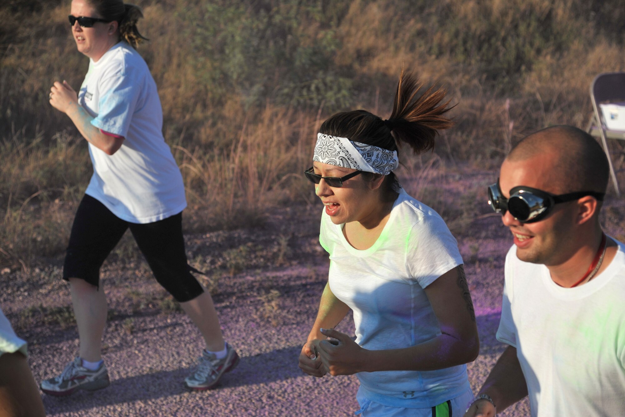 GOODFELLOW AIR FORCE BASE, Texas-- Airman 1st Class Victoria Gutierrez, 17th Medical Group mental health technician, finishes running through a color station during the Sexual Assault Prevention and Response Color Race on Kiowa Trail Aug. 17. Personally knowing a victim of sexual assault encouraged Gutierrez to participate in the 5k. (U.S. Air Force photo/Senior Airman Michael Smith)