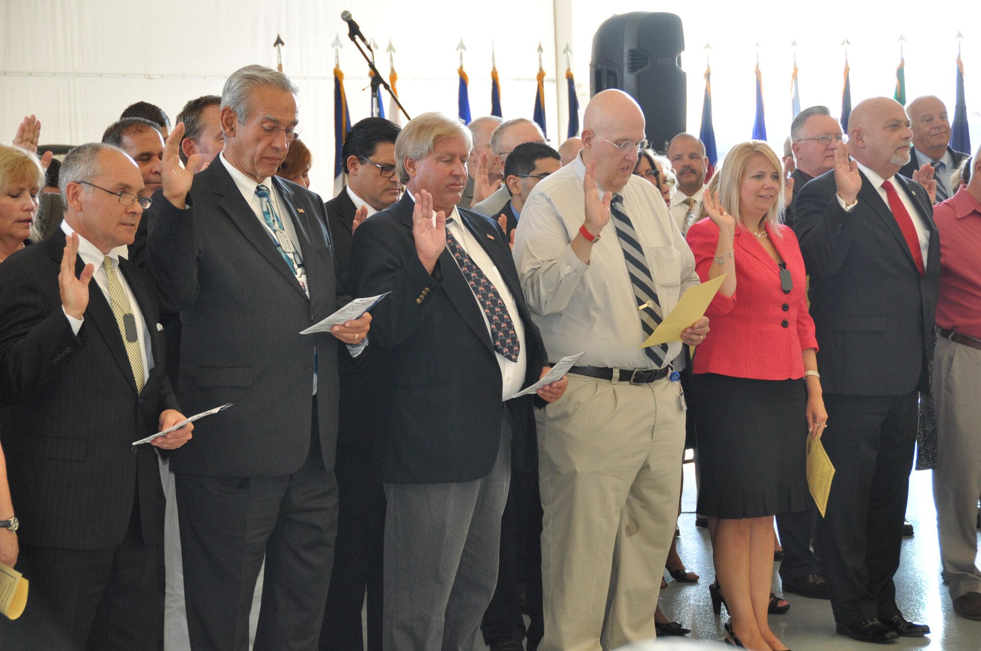 514th Air Mobility Wing honorary commanders partake in the Honorary Commanders oath at the induction ceremony held here Aug. 20. Local community leaders inducted as honorary commanders serve a one-year term working with base commanders to positively impact communities, increase base interaction and strengthen community ties (U.S. Air Force photo/Senior Airman Chelsea Smith).