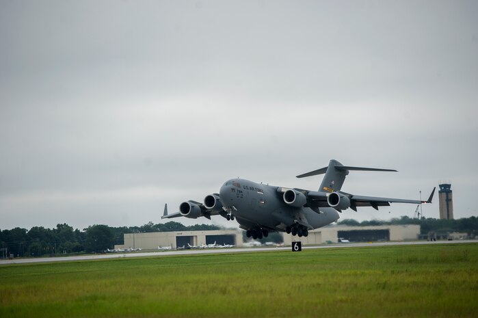 Col. Darren Hartford, 437th Airlift Wing commander, and Col. James Fontanella, 315th Airlift Wing commander, performs a touch-and-go Aug.16, 2013 on the newly opened runway at Joint Base Charleston - Air Base, S.C. The newly constructed runway is 9,000 feet long and 150-feet wide and 18-inches thick at a cost approximately $40 million.The new runway will be capable  of supporting Air Force mission requirements and also serve teh local community. In addition, the project added high efficiency LED lighting fixtures, improved infrastructure for naviational aids and an an updated aircraft arresting system used to safely recover fighter aircraft experiencing mechanical issues. (U.S. Air Force photo/Tech. Sgt. Douglas)
