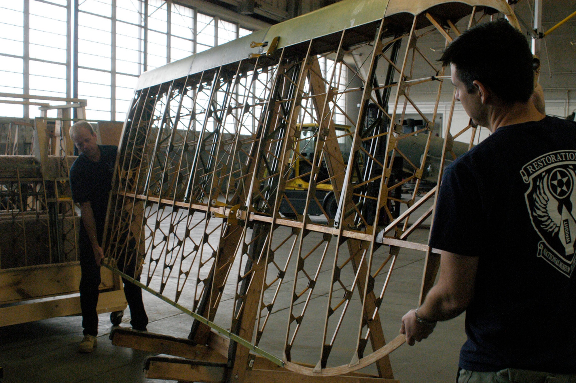 DAYTON, Ohio (08/2013) -- National Museum of the U.S. Air Force restoration specialists Brian Lindamood (left) and Casey Simmons lift one of the wings from the Stearman PT-13D Kaydet. (U.S. Air Force photo)